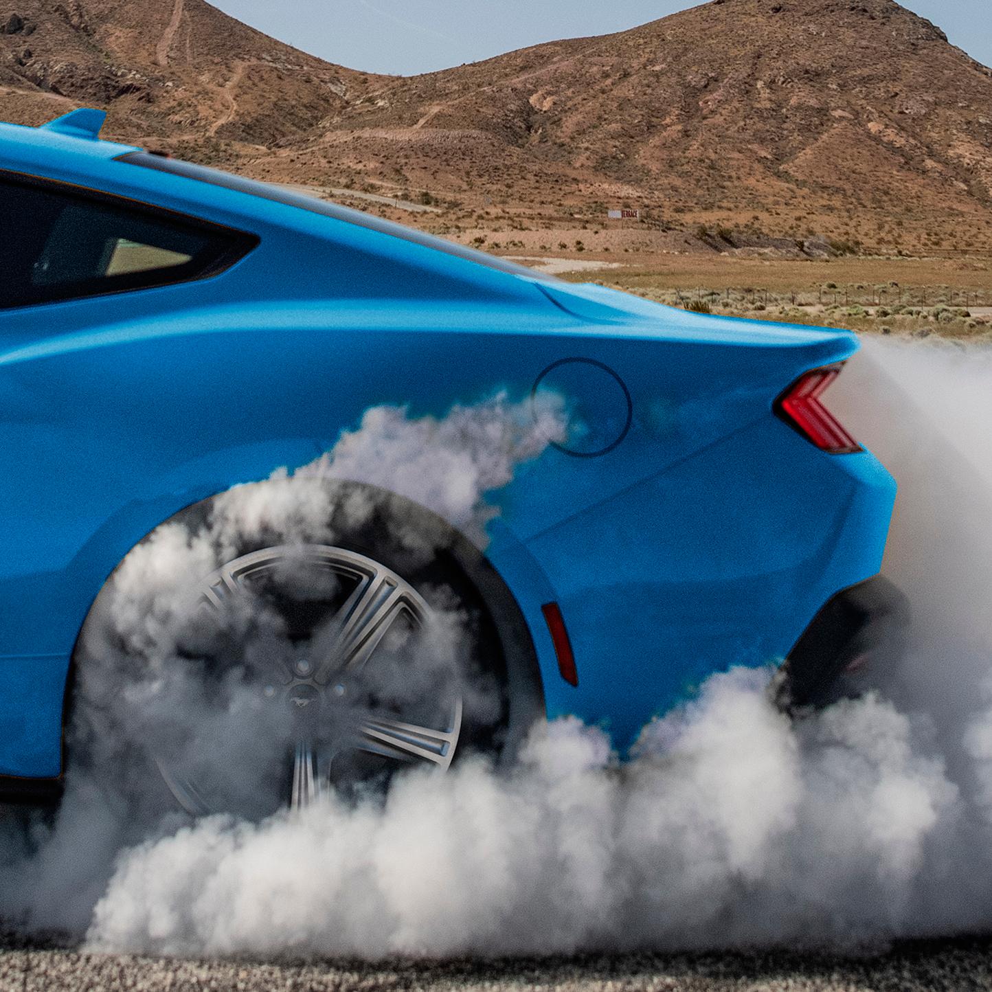 2026 Ford Mustang® EcoBoost® in Grabber Blue spinning around with smoke coming out of back tire