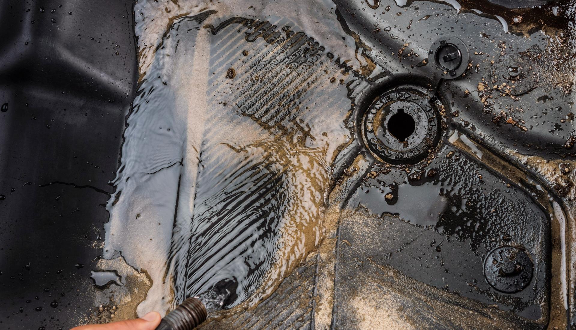 Water and mud draining through the drain plugs in the rubberized floor mats on a 2025 Ford Bronco® SUV