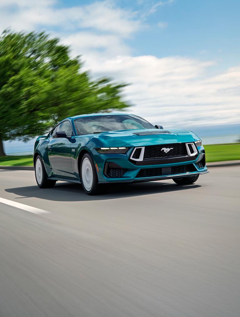 A 2026 Ford Mustang® GT Premium with the available FX Package being driven near a lake