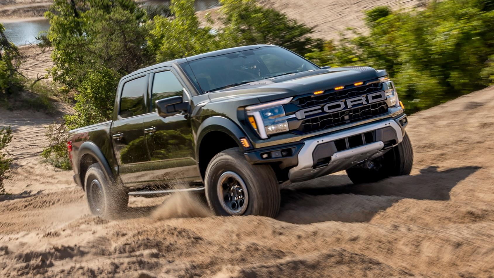 2025 Ford F-150® Raptor® pickup in Shelter Green Metallic being driven on a rocky desert path