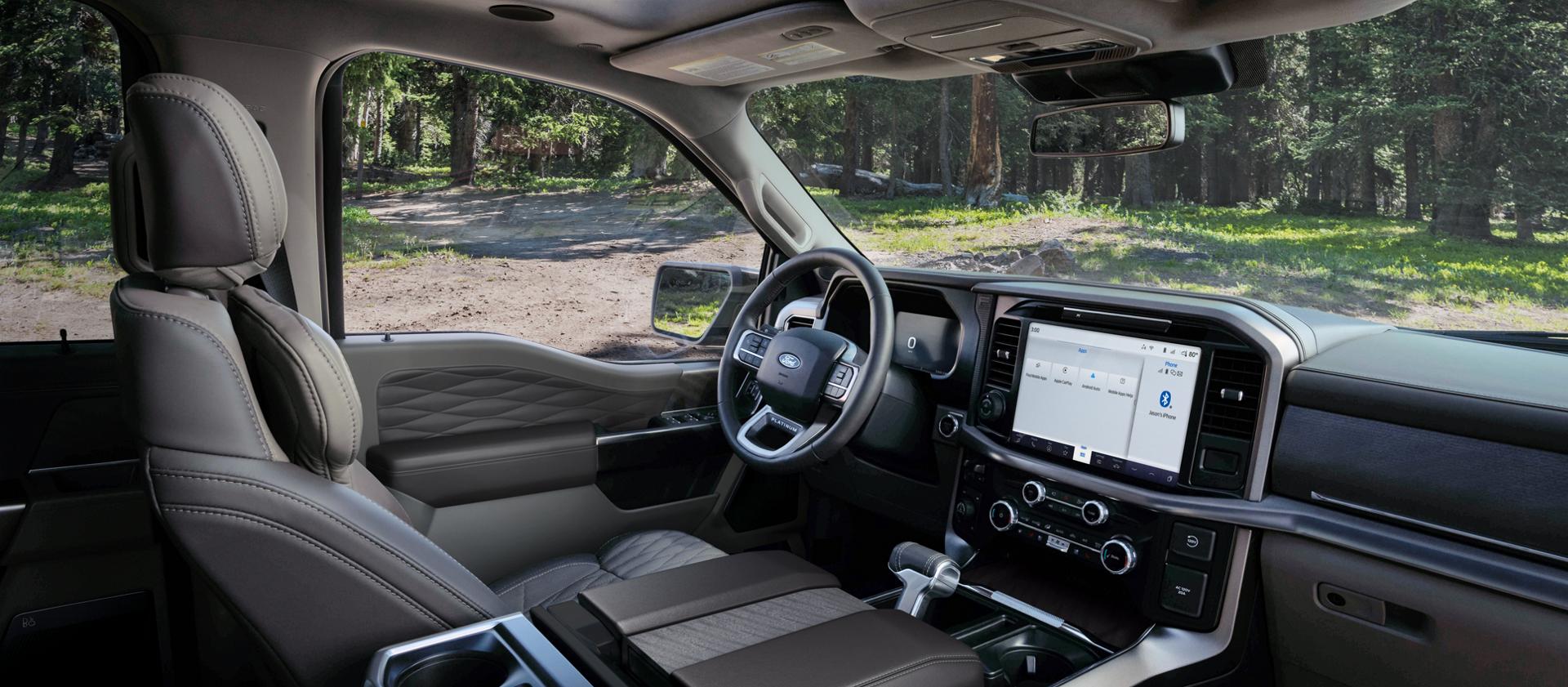 Interior of a 2026 F-150® Platinum® model parked in a wooded setting