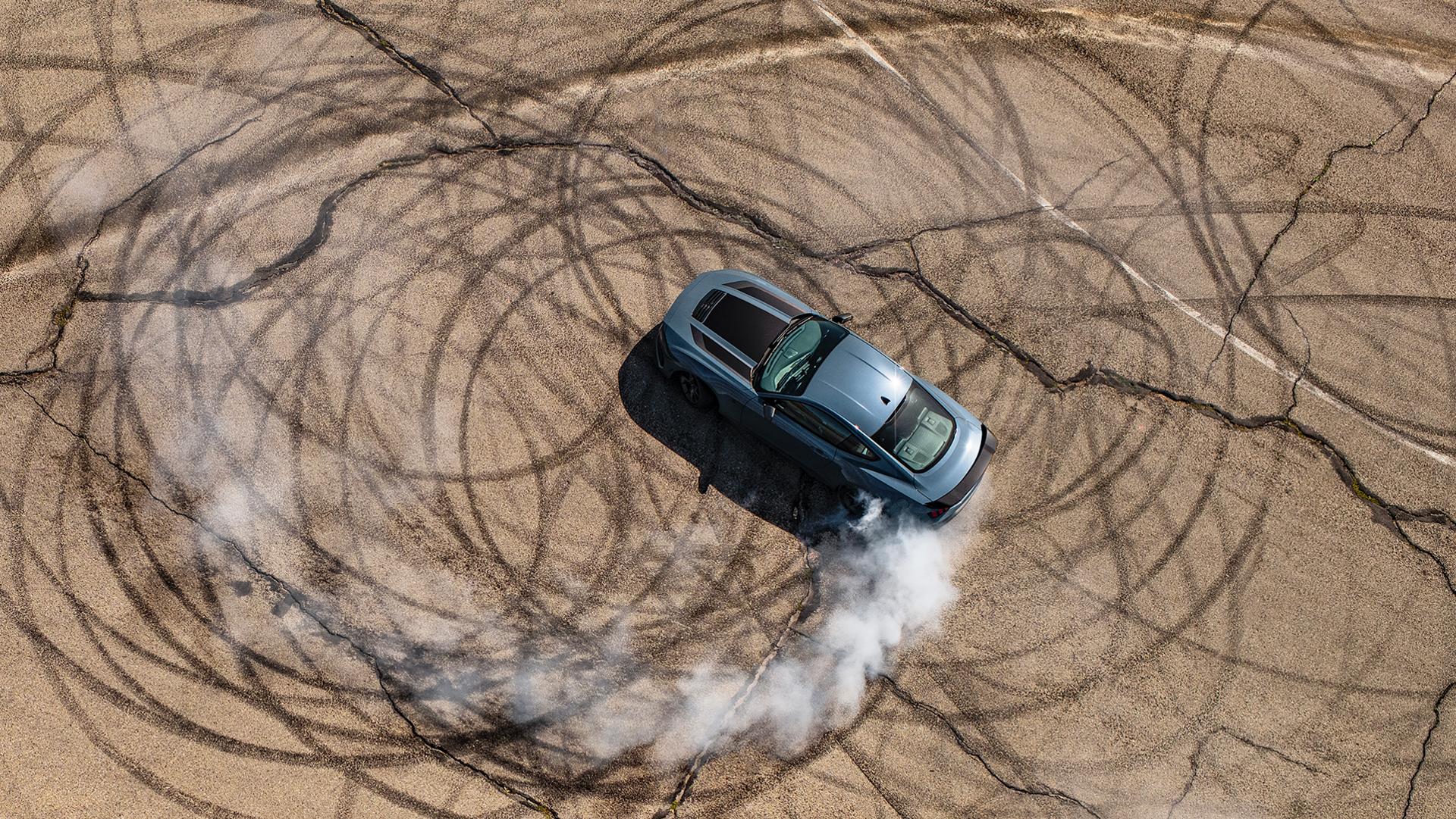 2026 Ford Mustang® Dark Horse™ coupe in Vapour Blue Metallic with a driver performing burnouts on a closed course