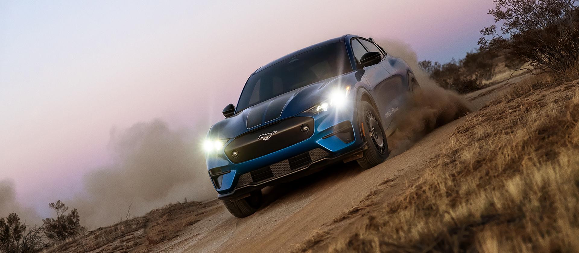 U.S. 2026 Ford Mustang Mach-E® Rally model being driven on a dirt road