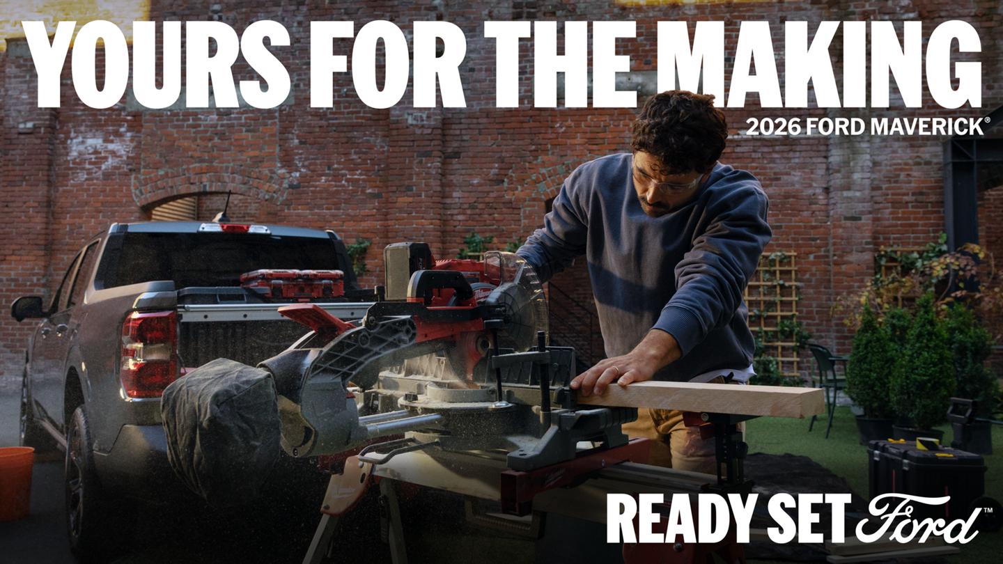 A man cuts wood with a power miter saw outdoors in front of a Carbonized Grey 2026 Ford Maverick truck, set against a brick building. Headline reads "YOURS FOR THE MAKING".