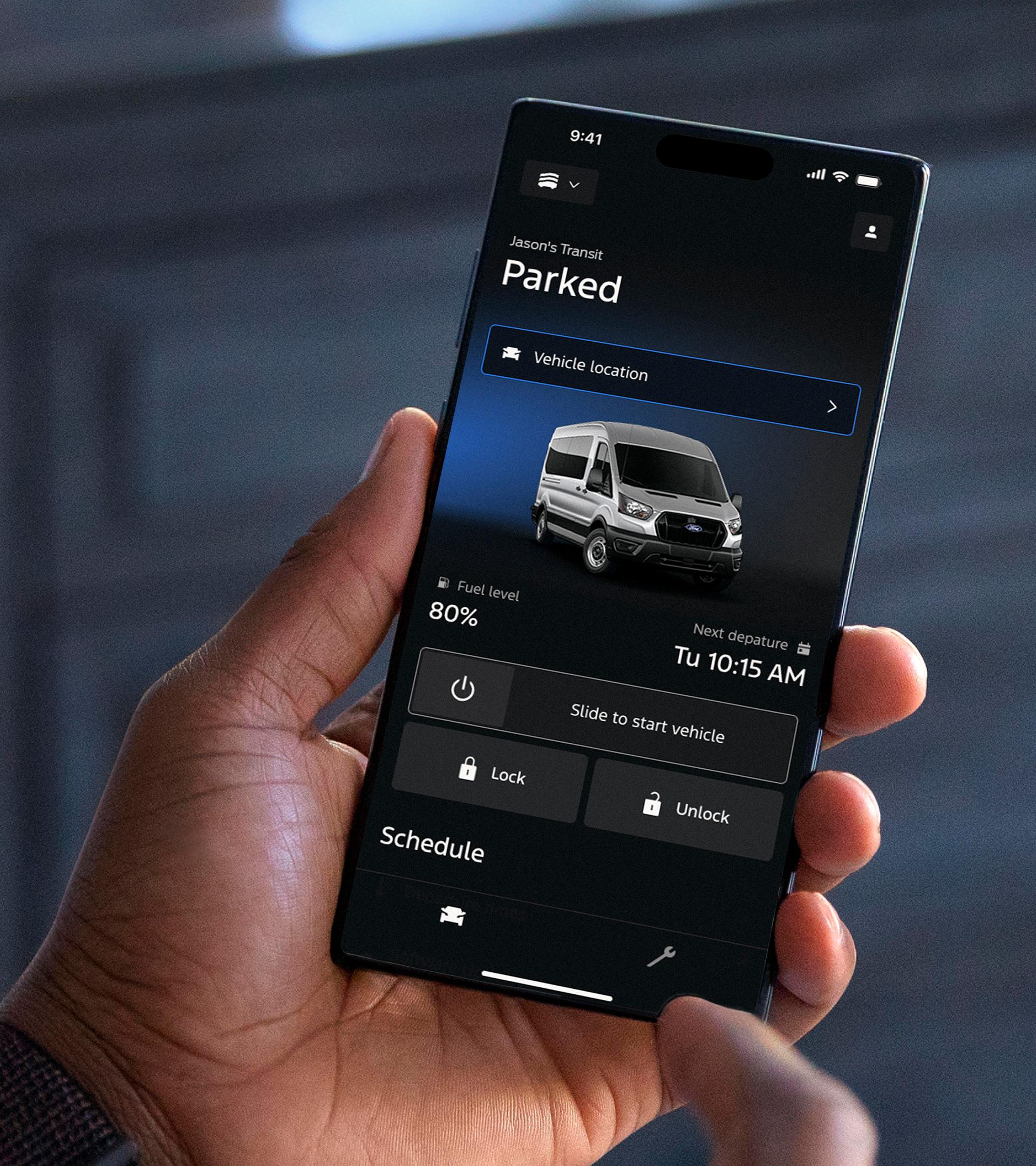 Hand holding a mobile phone with the Ford app home screen in view