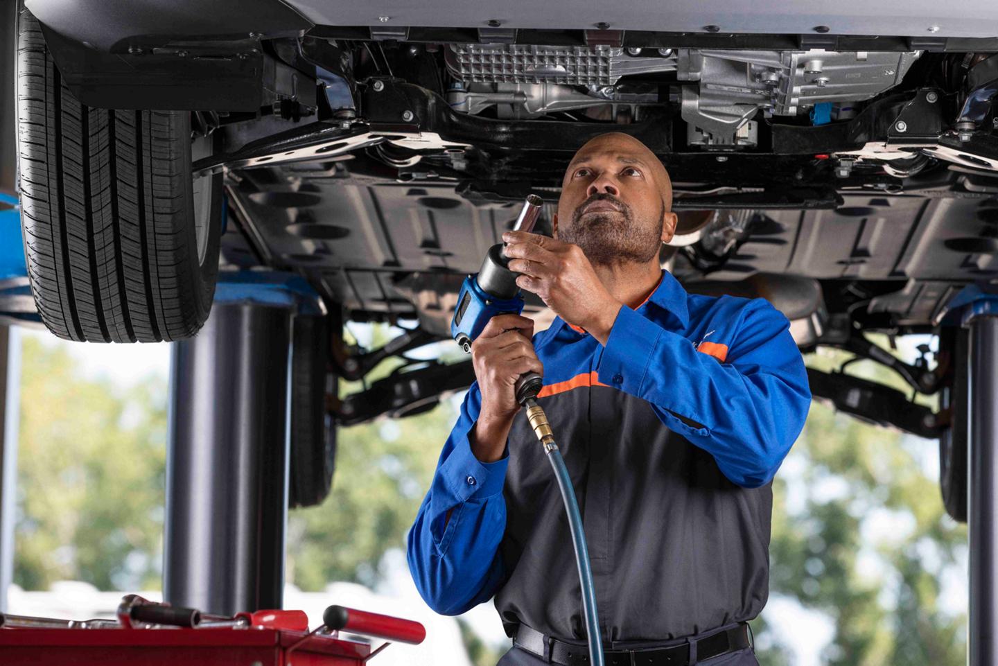 A Ford Service garage with a man performing maintenance on a Ford vehicle
