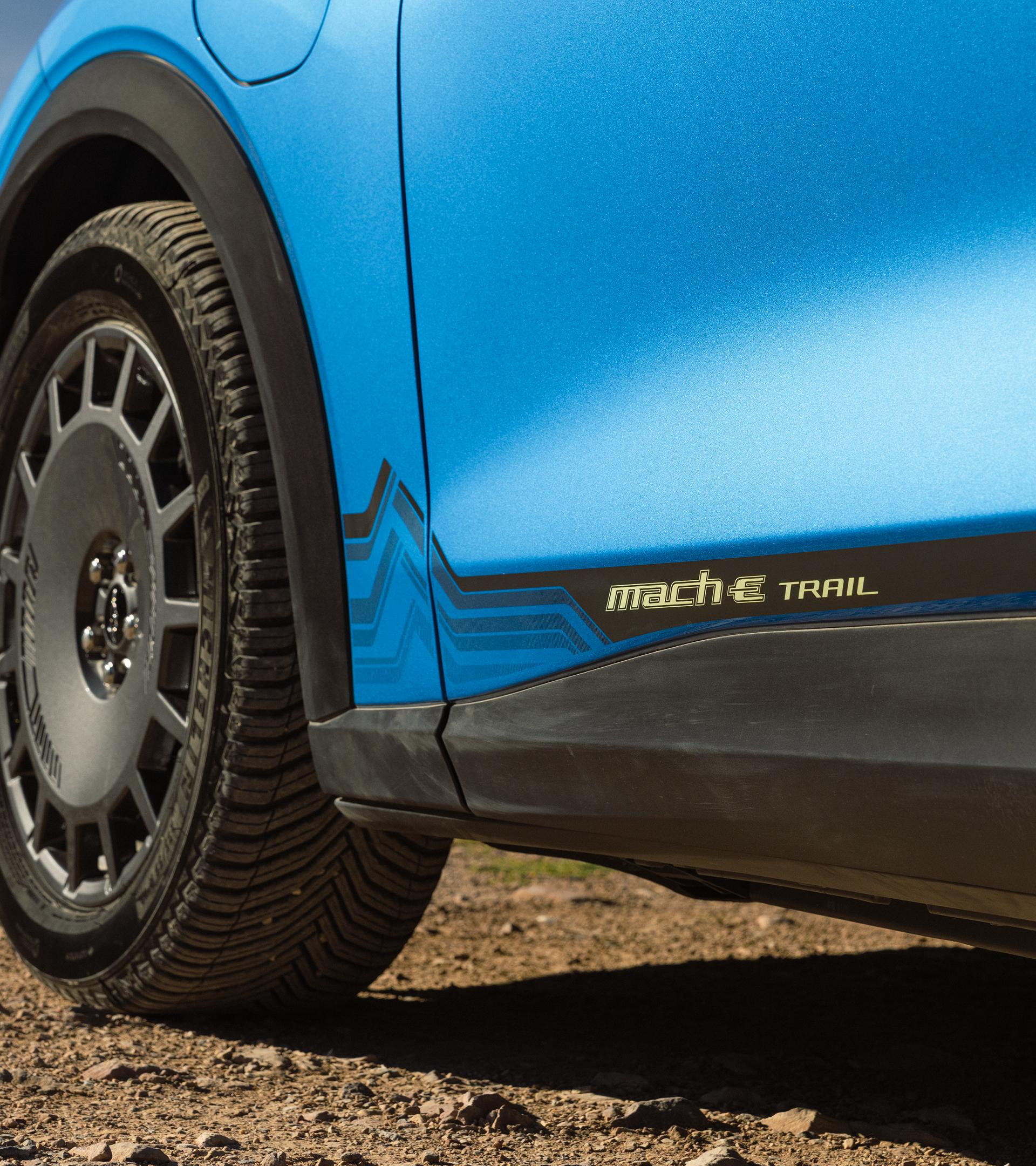 Close up of the 19” high-gloss Dark Carbonized Gray wheels and Michelin CrossClimate2 all-season performance tires on the 2027 Mustang Mach-E® SUV with optional Trail package
