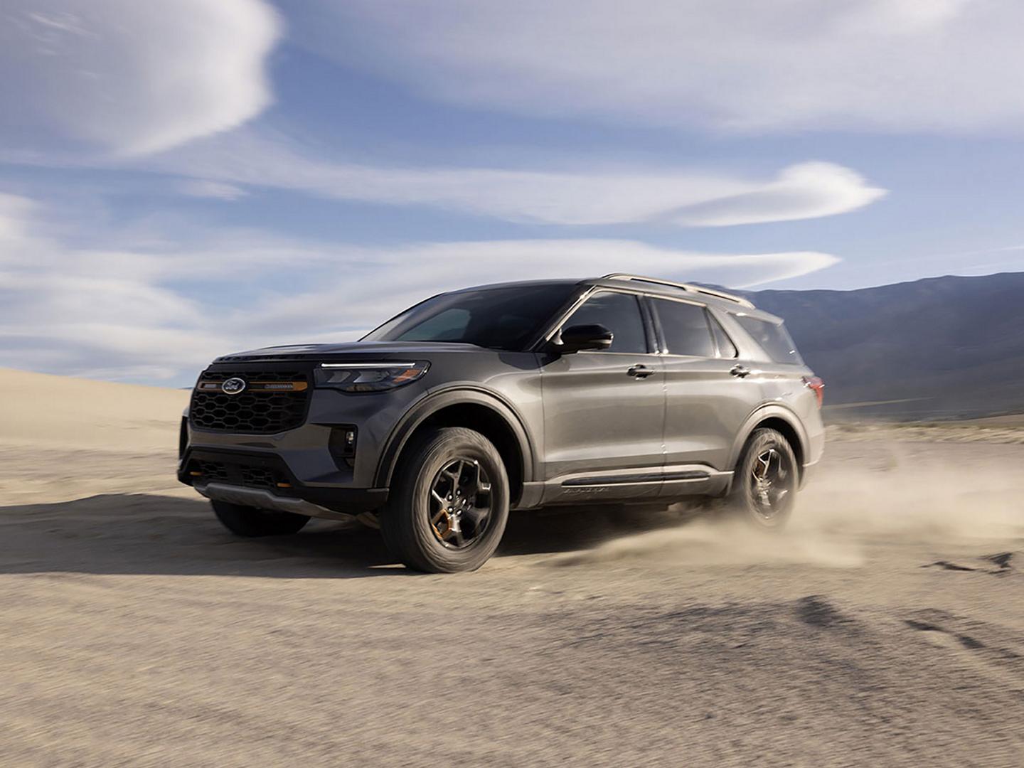 A 2027 Ford Explorer® SUV kicking up sand on a salt flat