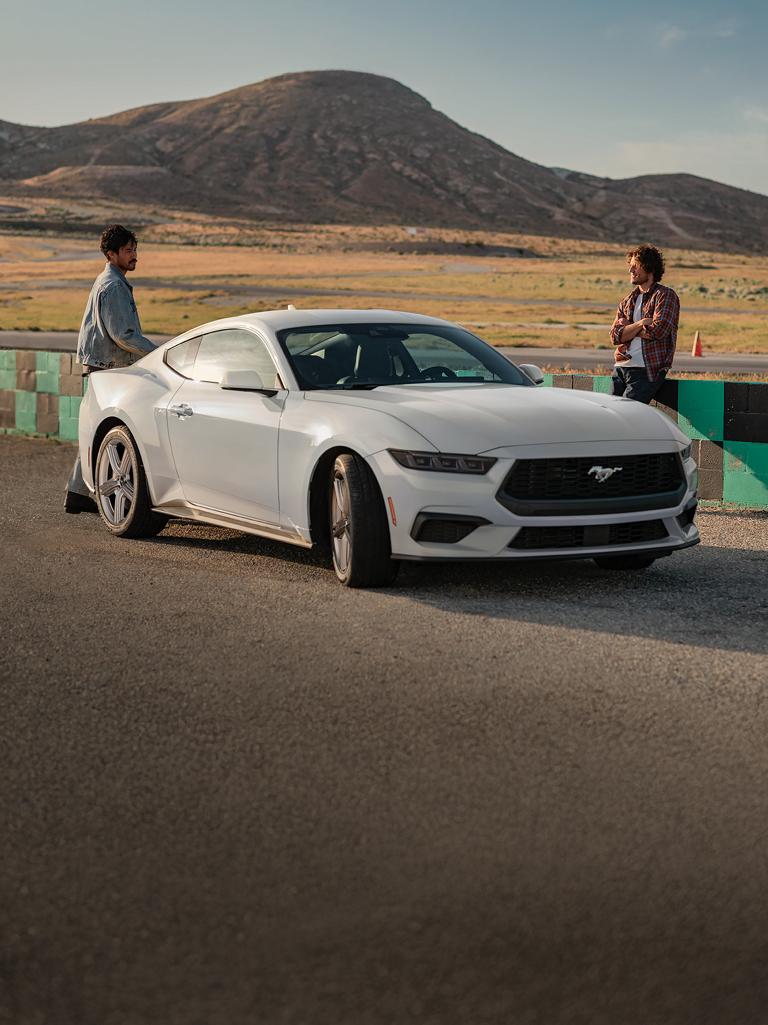 2026 Ford Mustang® EcoBoost® fastback parked on a racecourse near people
