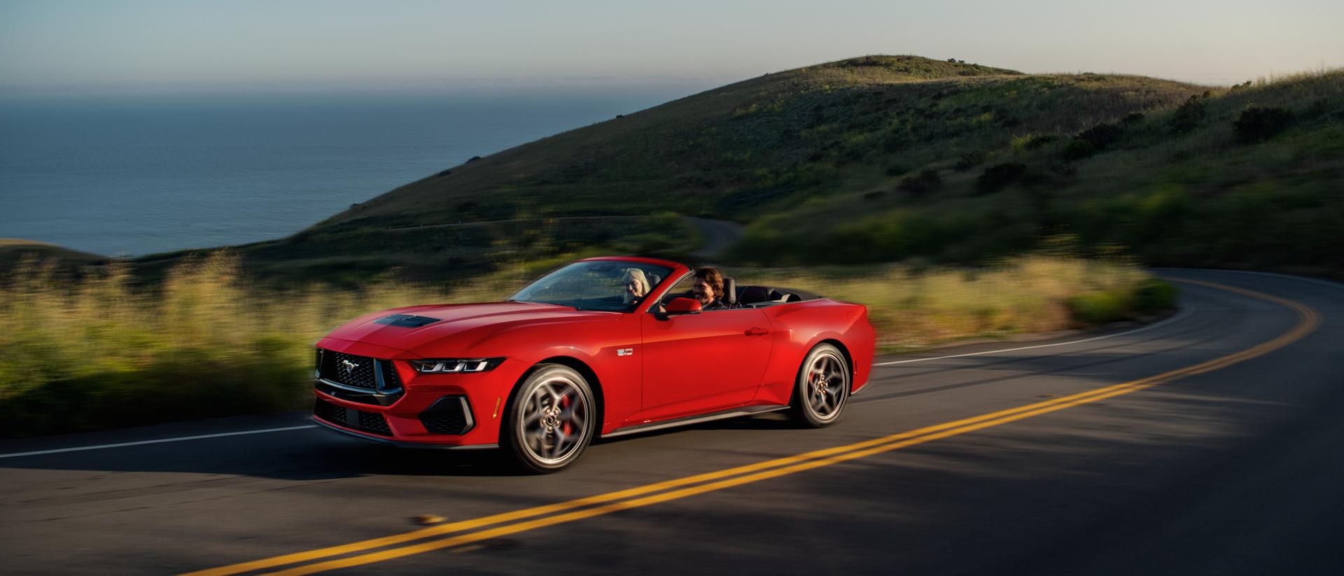2025 Ford Mustang® GT convertible being driven on a hill