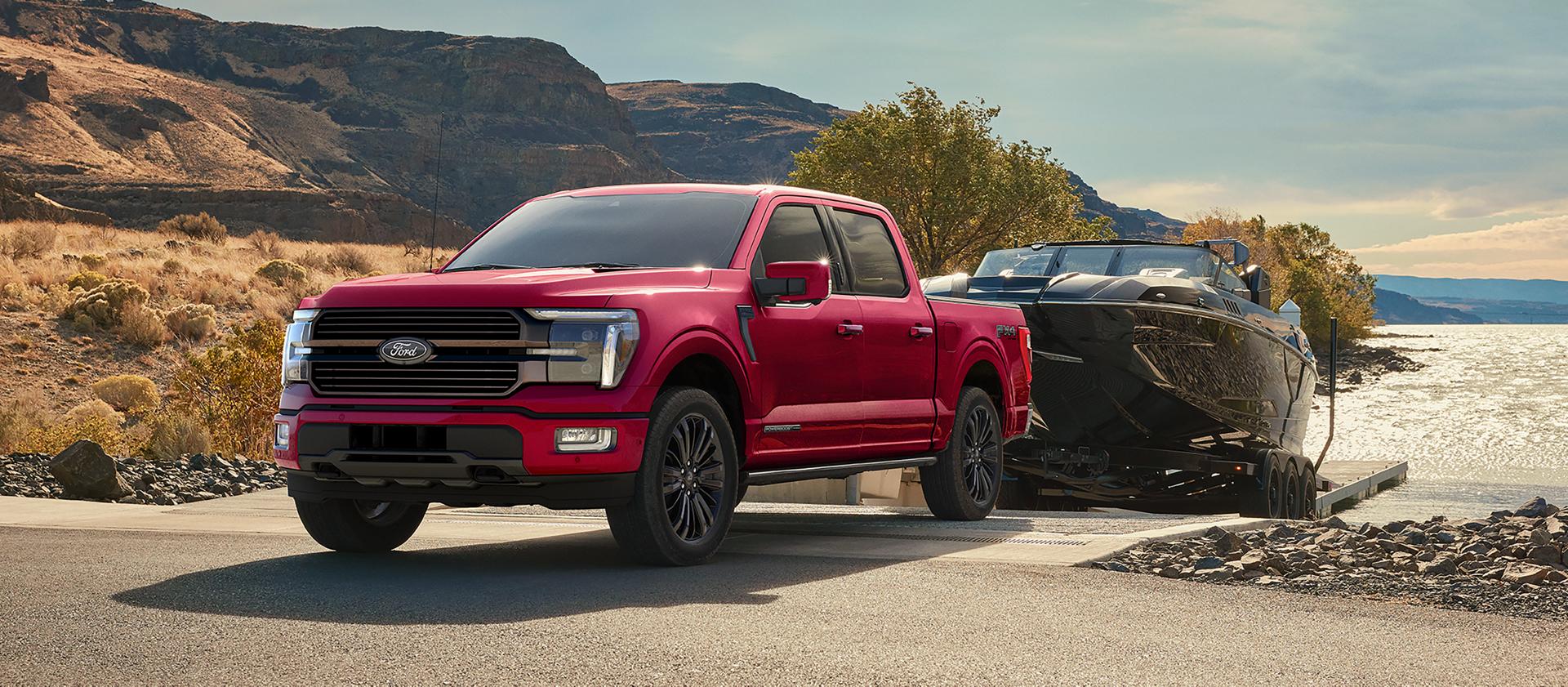 2026 Ford F-150® STX® FX4 pickup in Ruby Red pulling a boat out of the water
