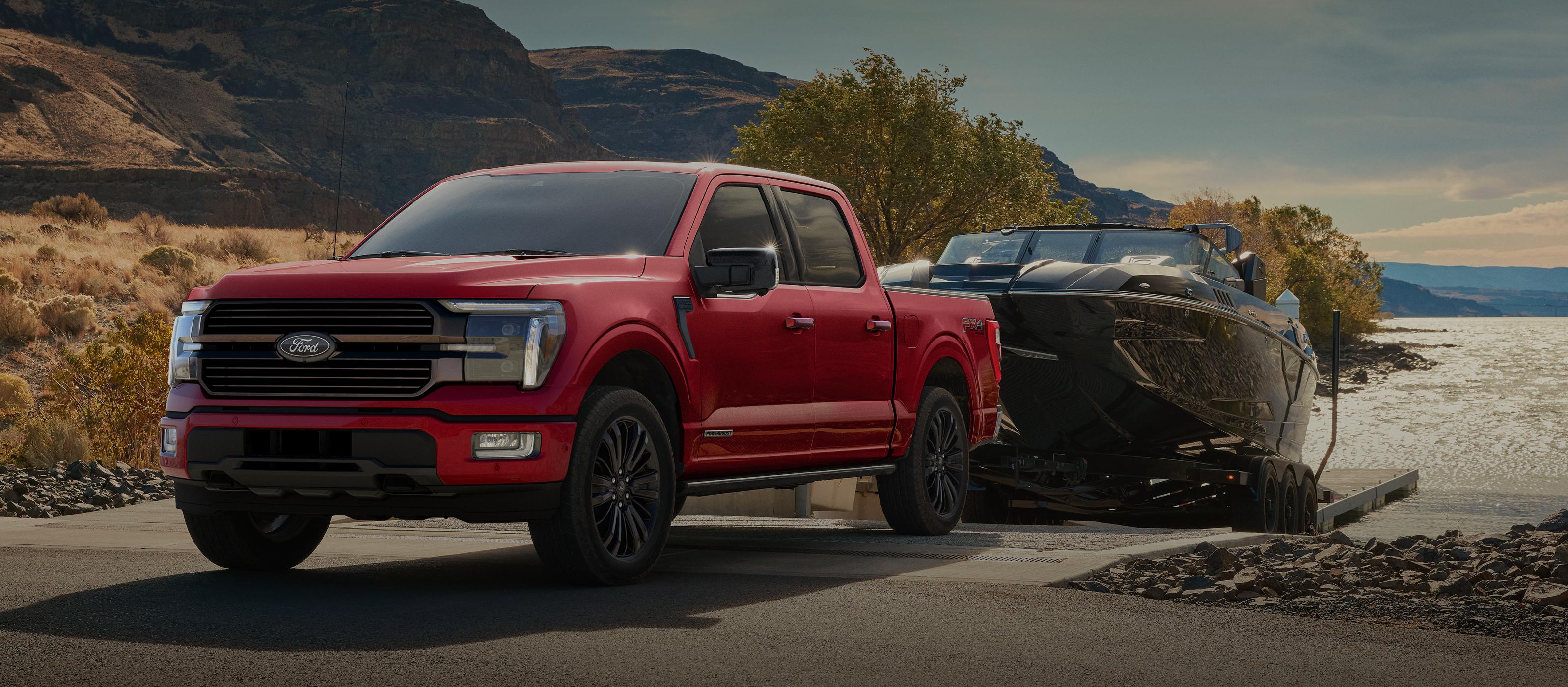 2025 Ford F-150® pickup backing a trailered boat into a lake slipway