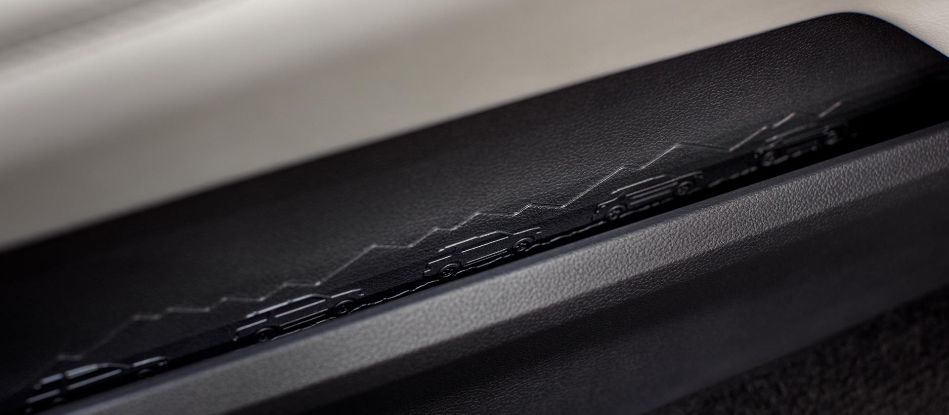 A close-up of the interior details on a 2026 Ford Explorer® SUV, showing an embossed mountain scene