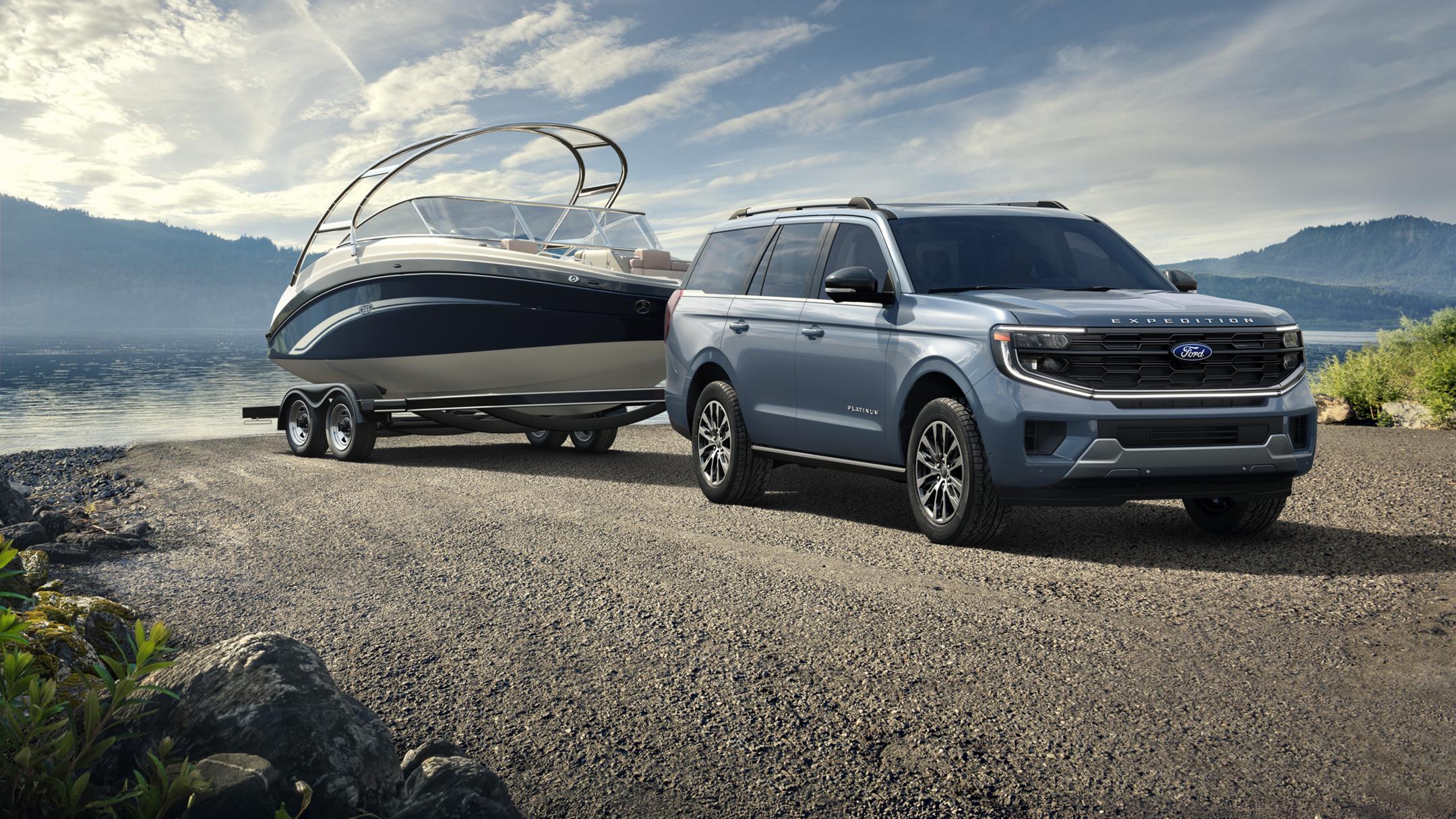 Ford Expedition with boat trailer parked by a lake.