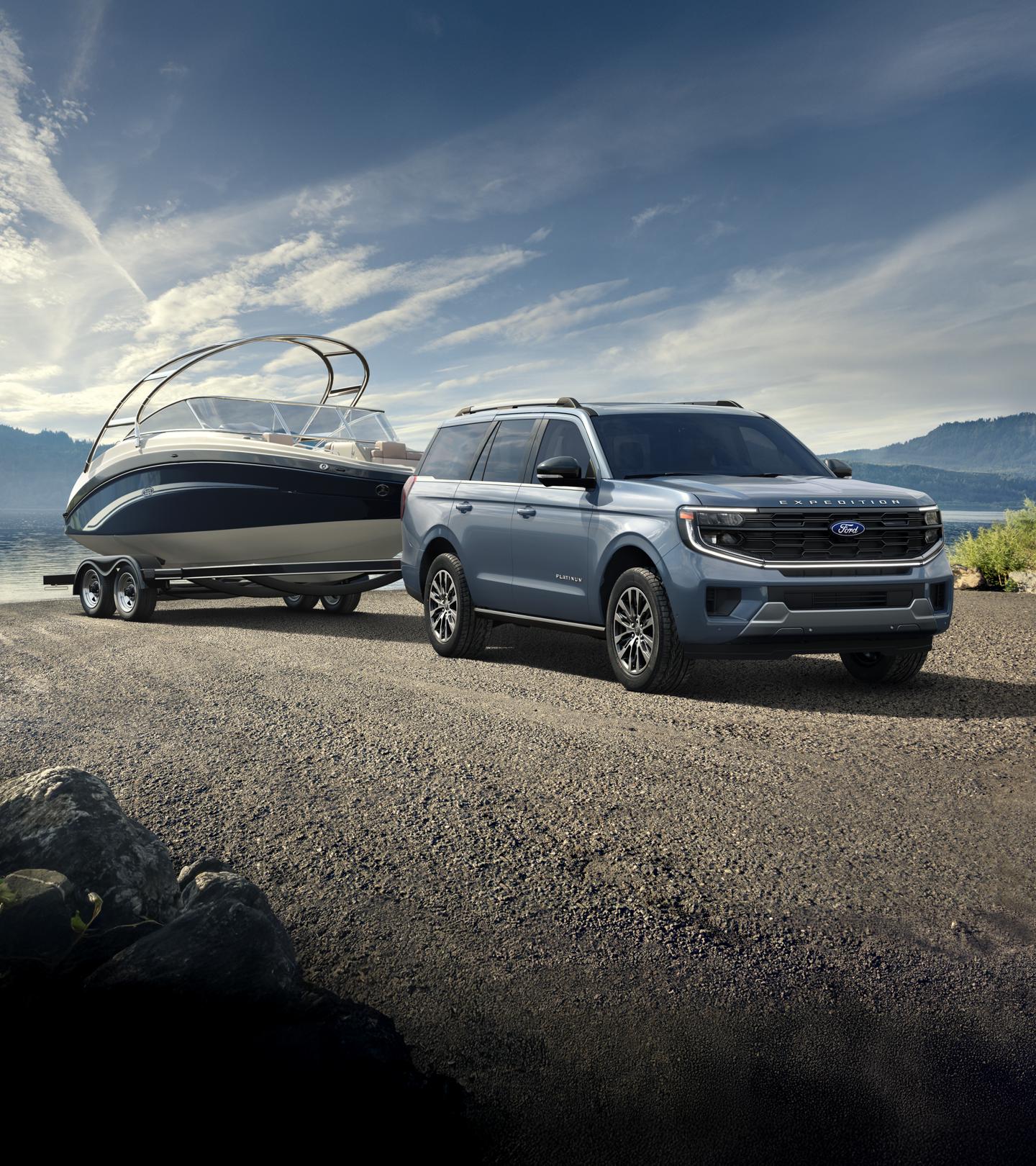 Ford Expedition with boat trailer parked by a lake.
