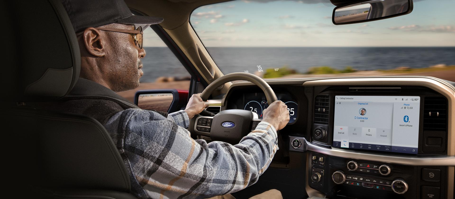 Man driving a 2026 F-150® pickup showing the centre display