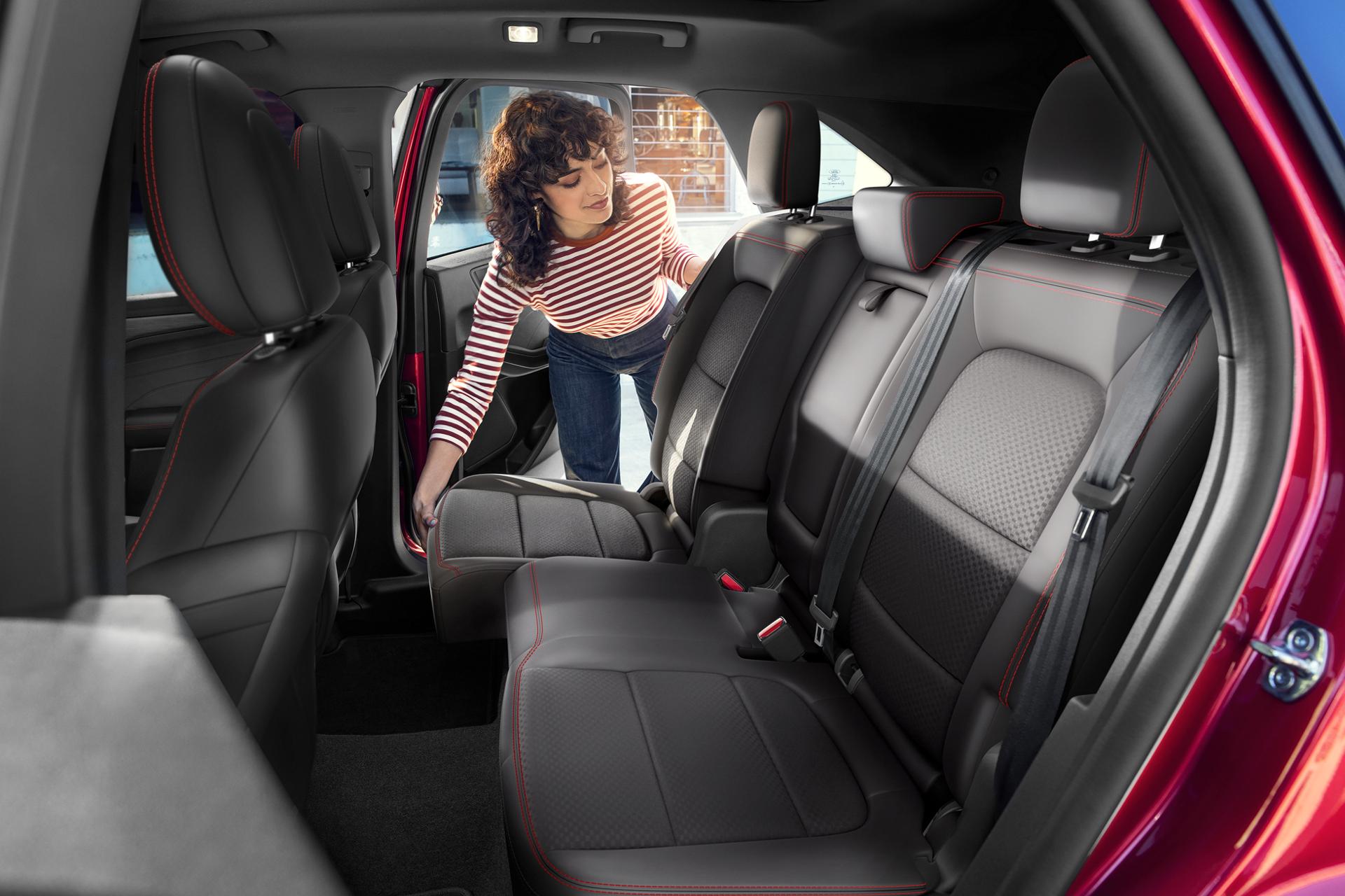 Woman adjusting the 60/40 split-fold second row in the 2026 Ford Escape® SUV