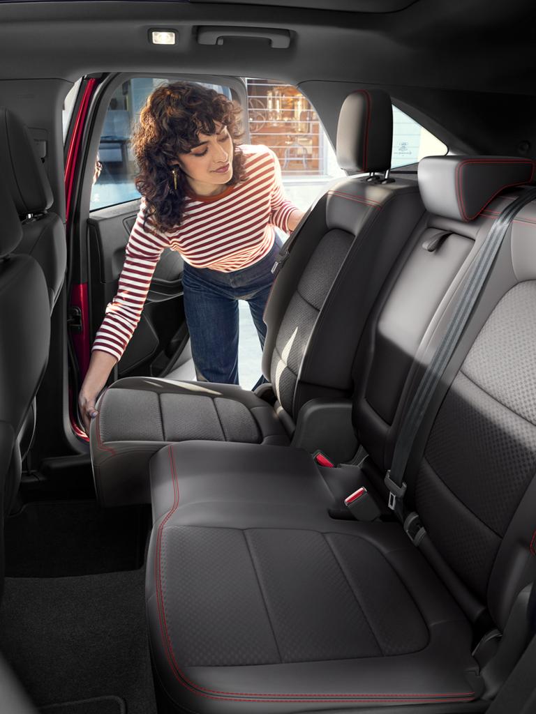 Woman adjusting the sliding second row seats in a 2025 Ford Escape® SUV