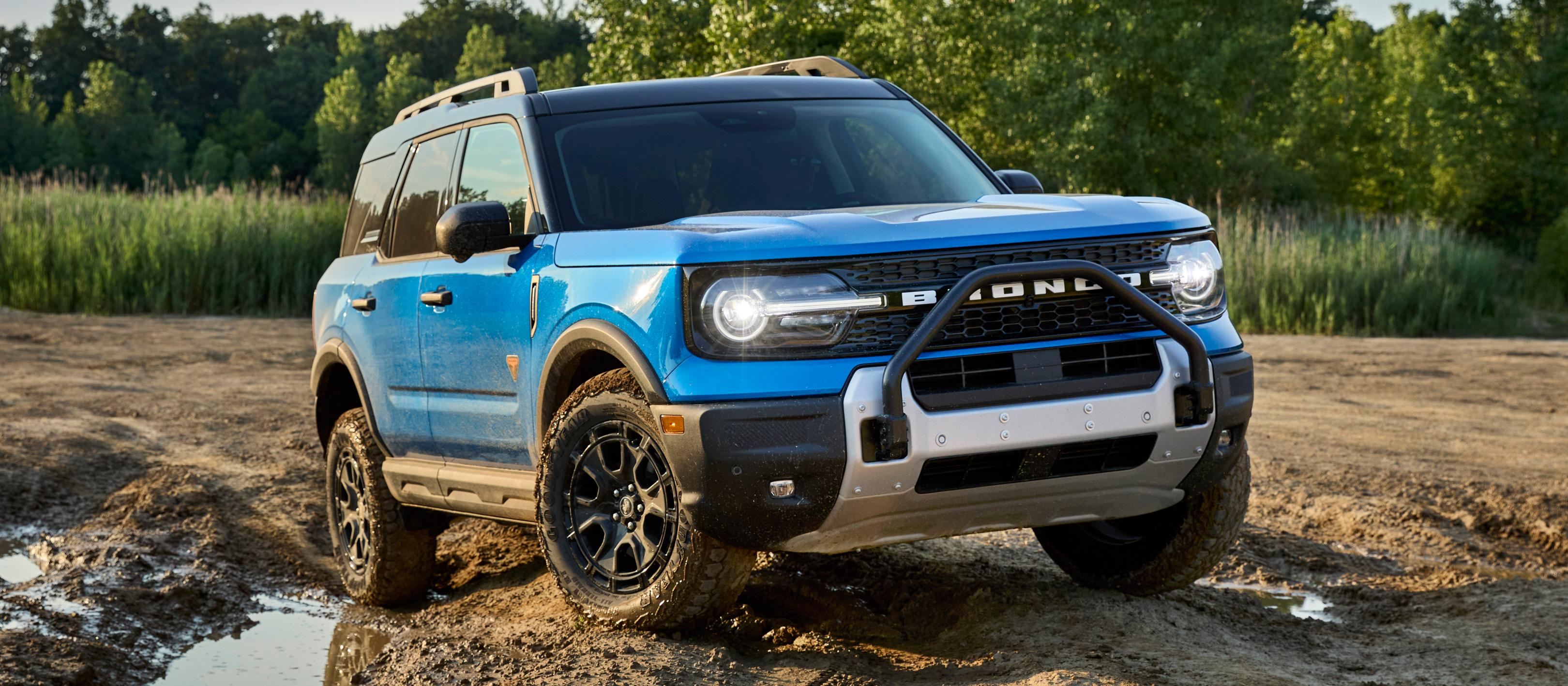 2025 Ford Bronco Sport® being driven in the dirt and near a mud puddle