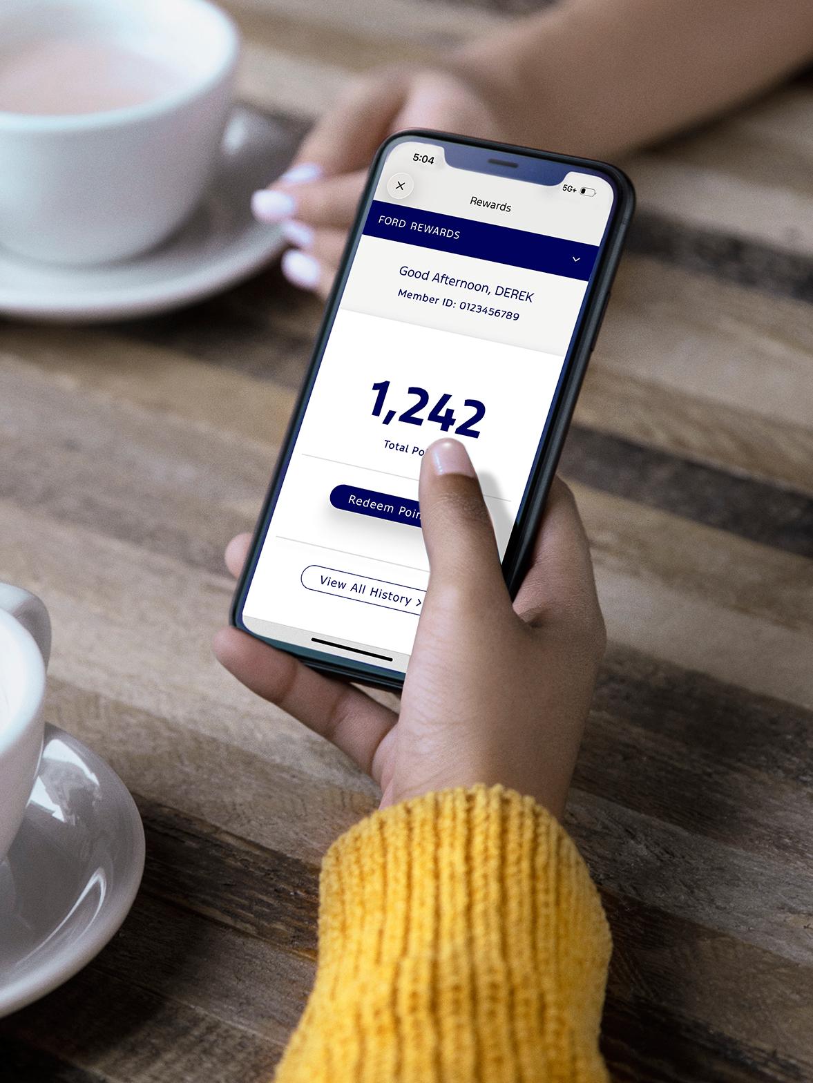 A phone displaying the Ford Rewards App.