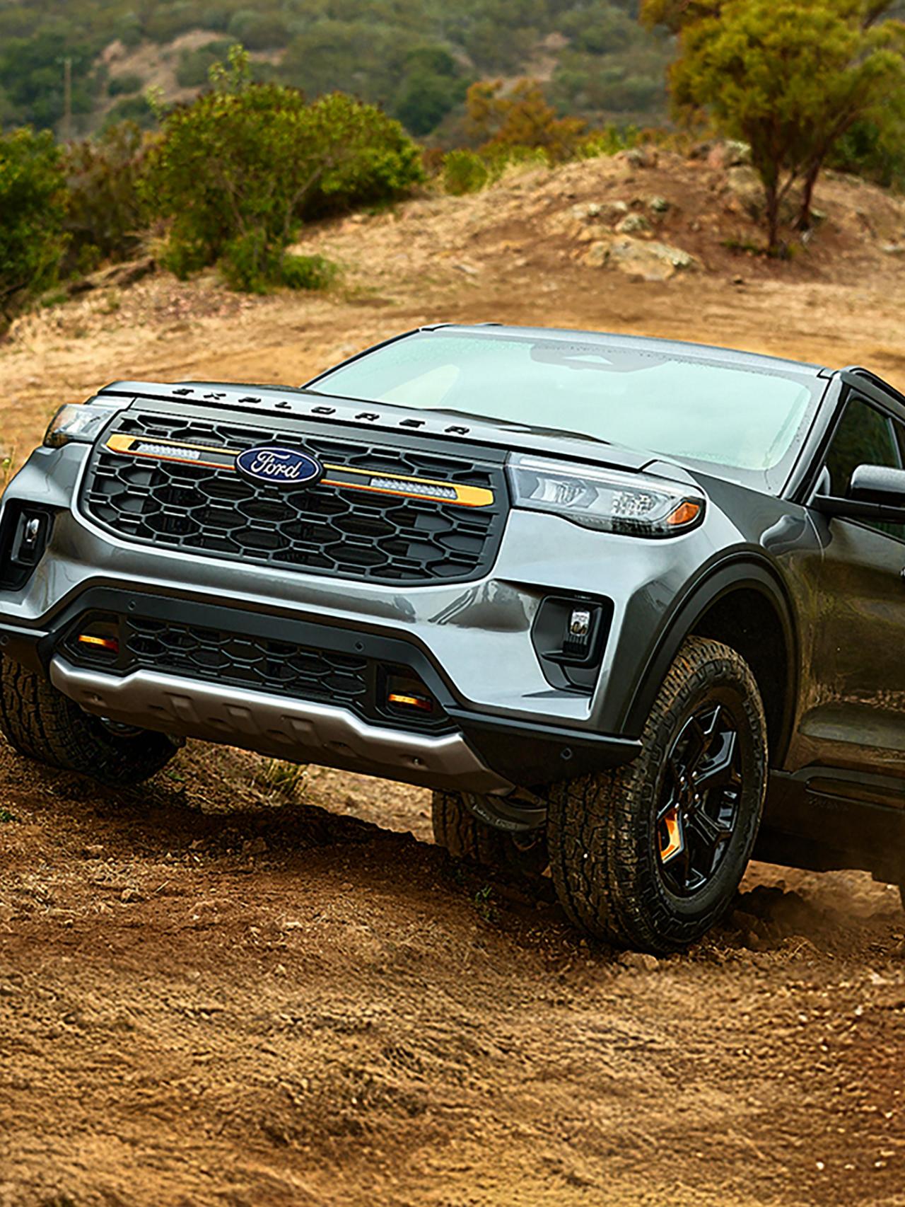 A 2027 Ford Explorer® Tremor® model climbing a grassy hillside