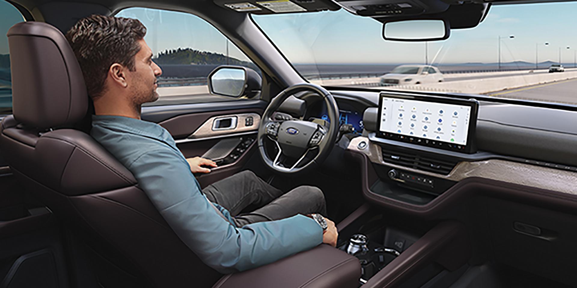 A man driving a 2027 Ford Explorer® SUV with the available BlueCruise hands-free highway driving feature activated