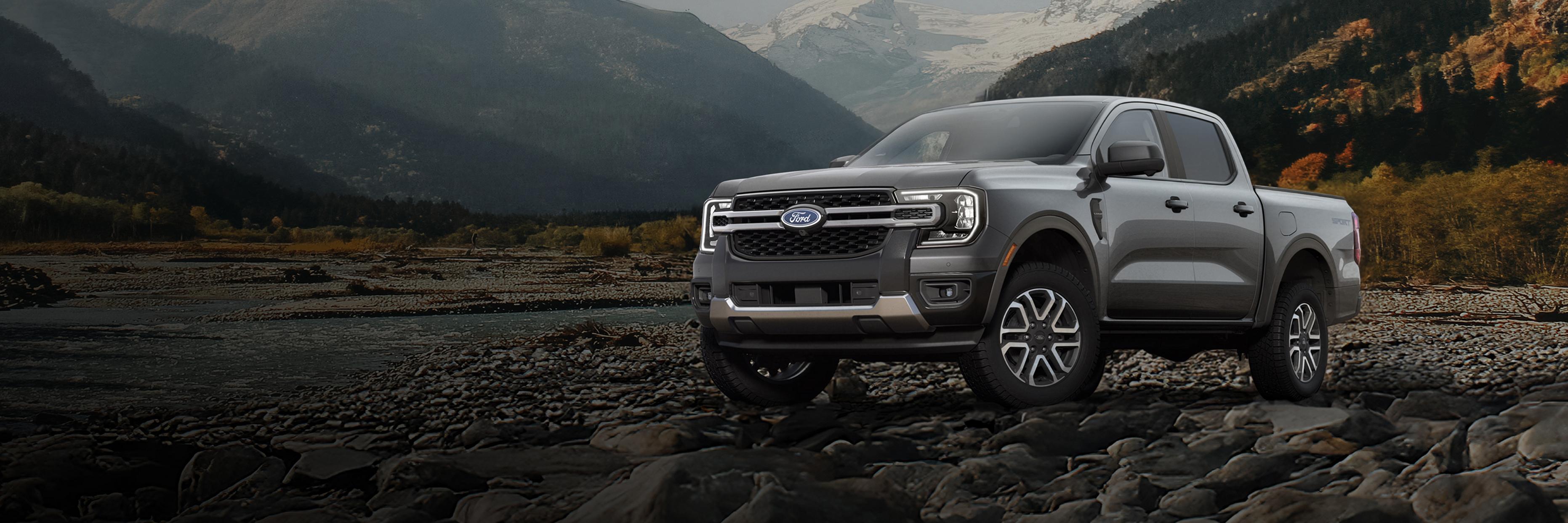 A 2026 Ford Ranger® Lariat® model parked on a rocky river bank in the mountains