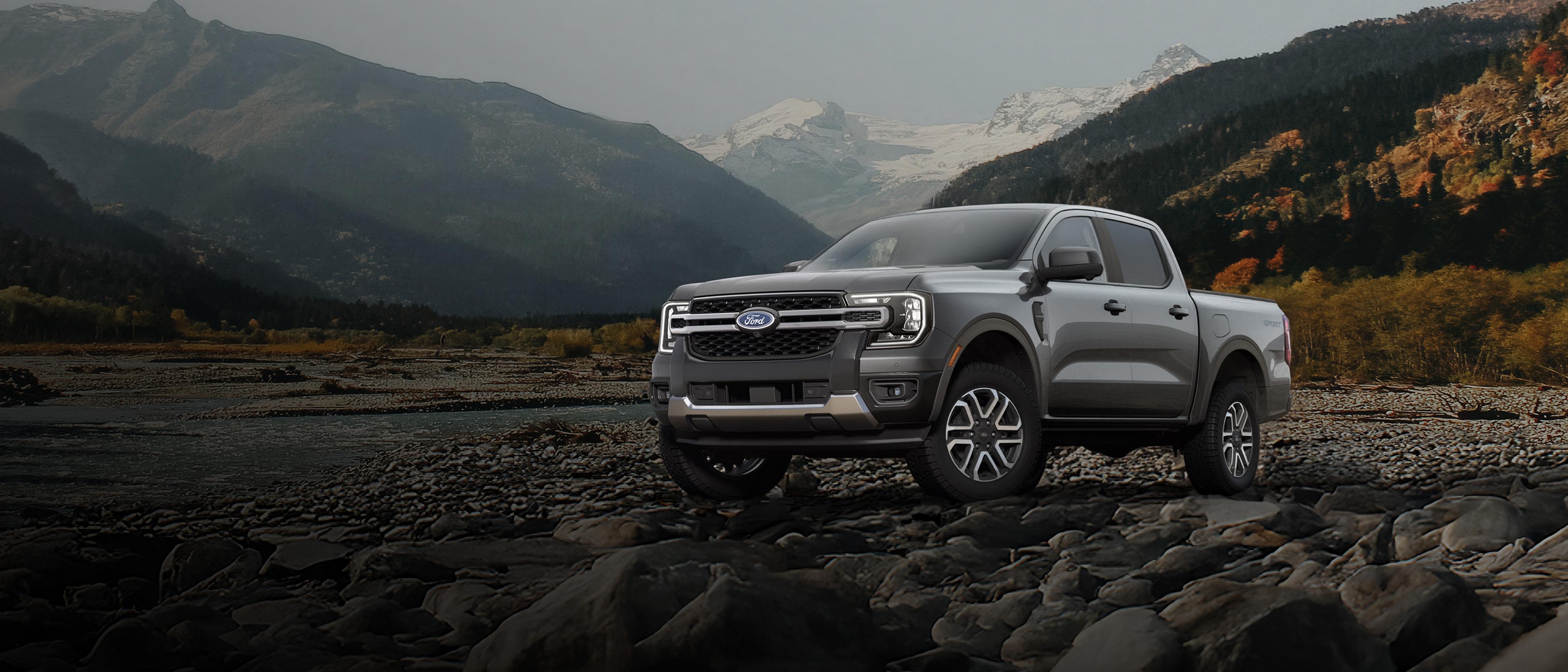 A 2026 Ford Ranger® Lariat® model parked on a rocky river bank in the mountains