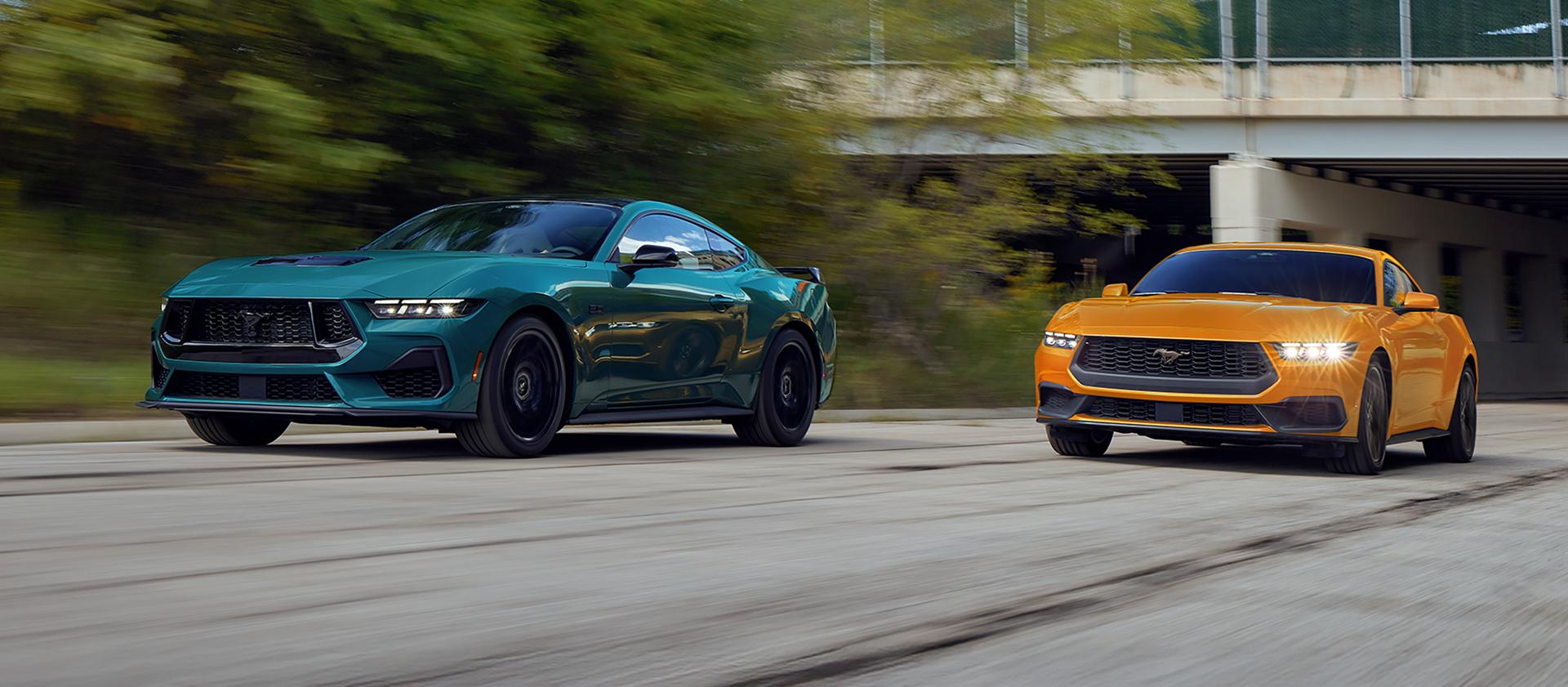 A 2026 Ford Mustang® GT fastback and a 2026 Ford Mustang® EcoBoost® fastback being driven on a highway