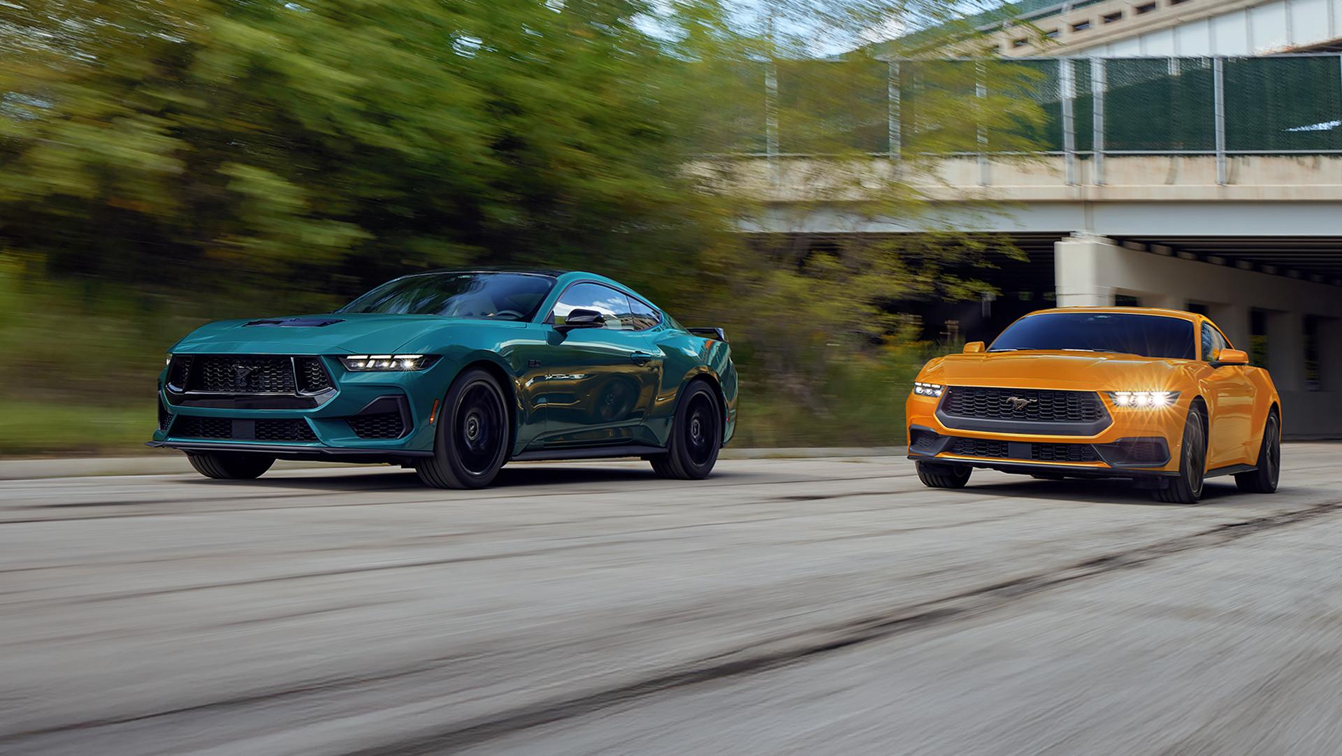 A 2026 Ford Mustang® GT fastback and a 2026 Ford Mustang® EcoBoost® fastback being driven on a highway