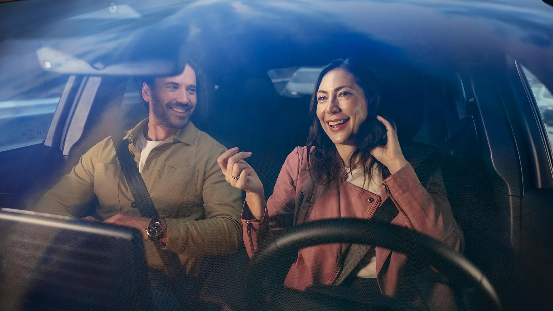 Two people inside a 2025 Ford Mustang Mach-E® seen through the windshield 