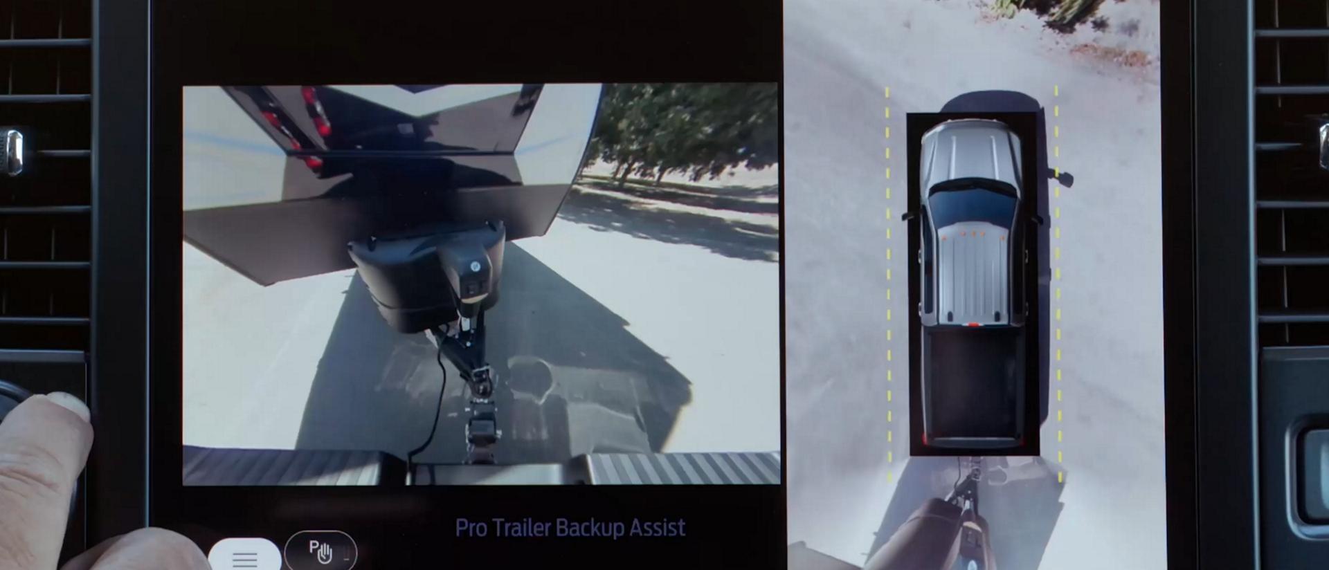 Close-up of a person using the Pro Trailer Backup Assist™ feature on the centre display