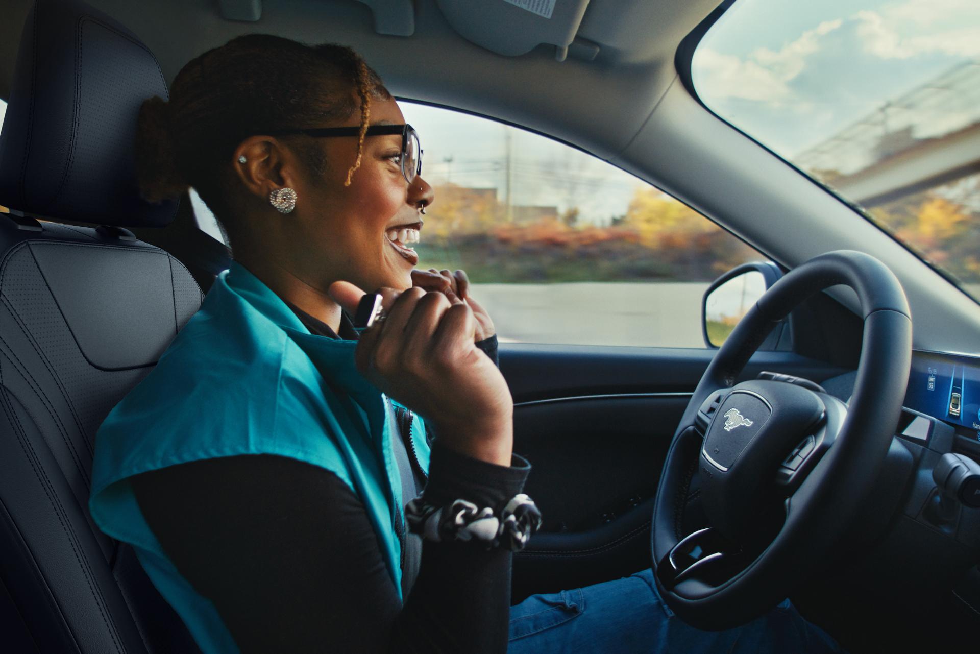 Person driving a Ford vehicle hands-free.