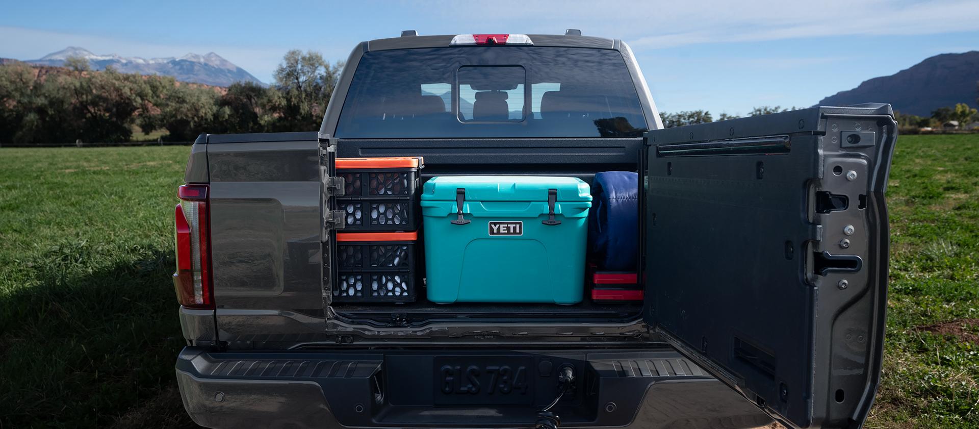2026 Ford F-150® Platinum® pickup in Agate Black Metallic highlighting the Pro Access Tailgate