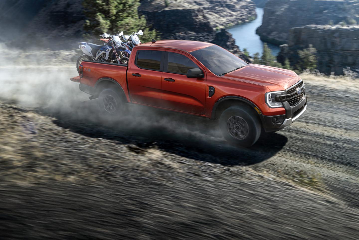 Ranger driving on a gravel road.