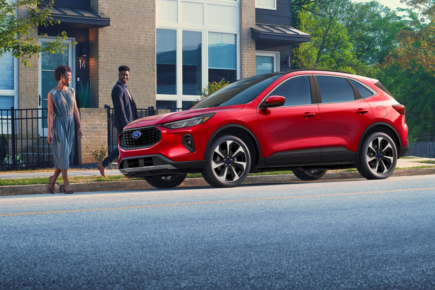 A red Ford Escape® parked outside a house.