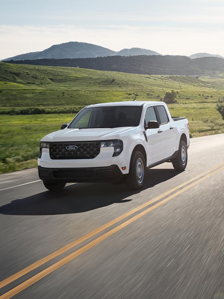 2026 Ford Maverick® pickup being driven near a hilly landscape