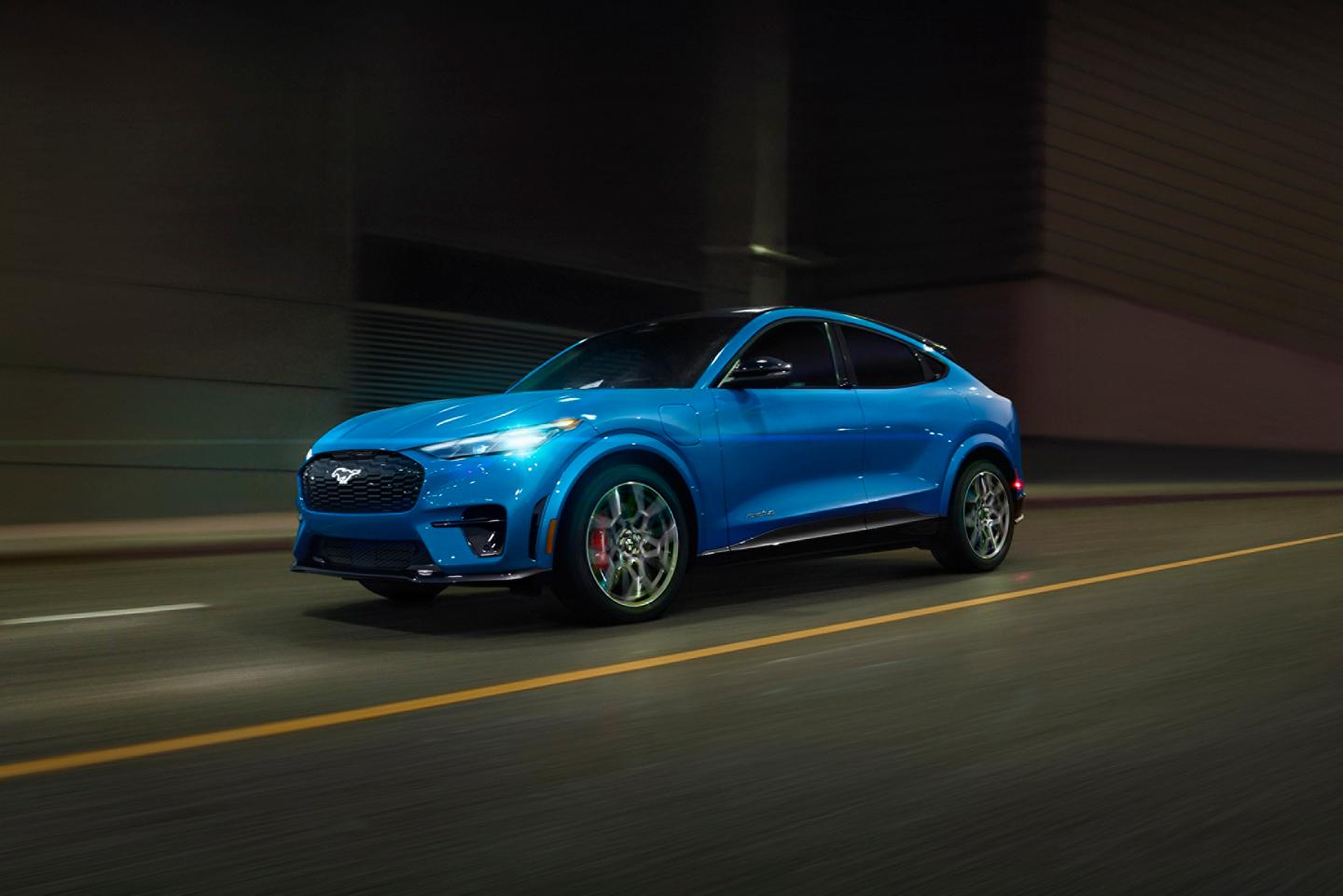 2026 Ford Mustang Mach-E® GT model being driven on a city street.
