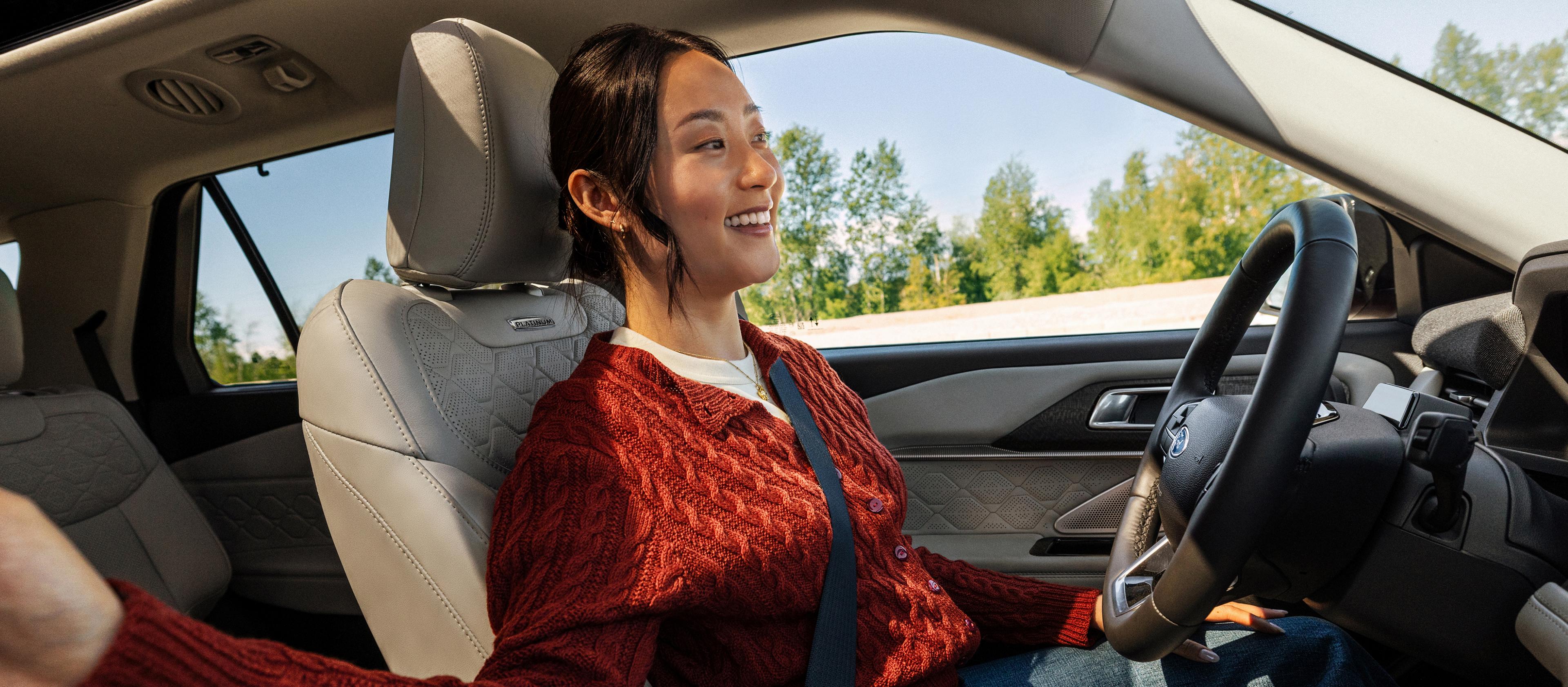 A person in a Ford Explorer® SUV driving down the highway, using the BlueCruise feature.