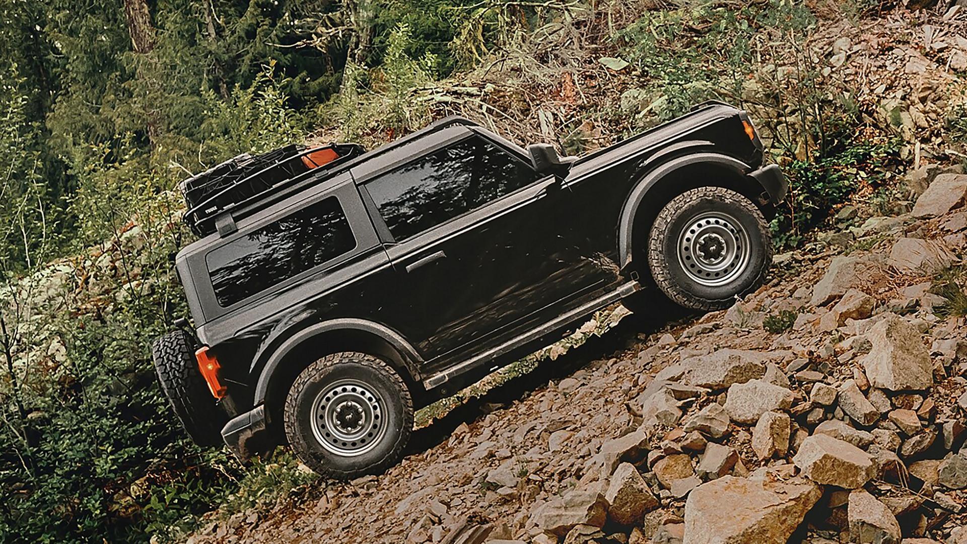 A 2026 Ford Bronco® SUV climbing a steep, rocky hill