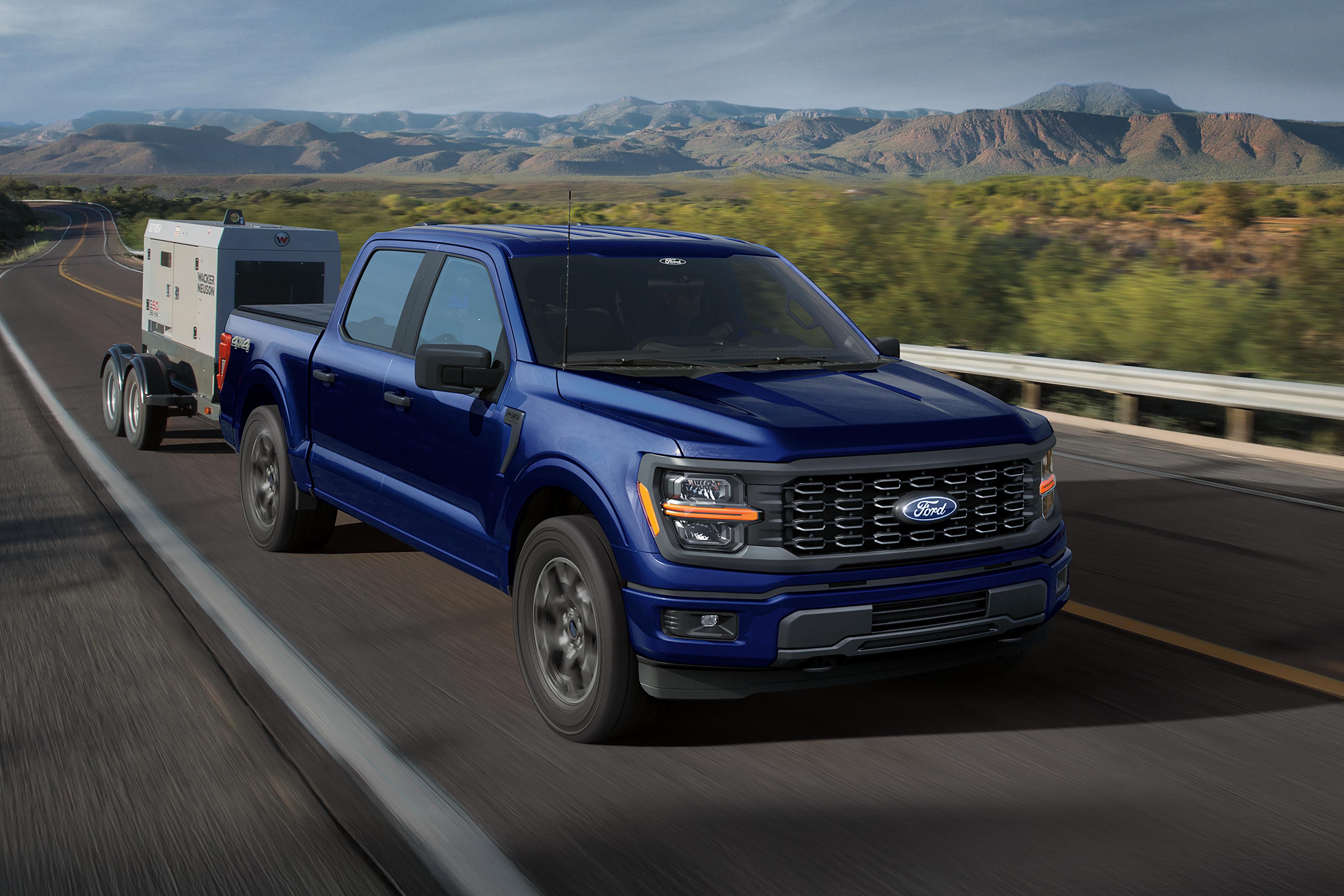 2026 Ford F-150® XL pickup pulling a small trailer
