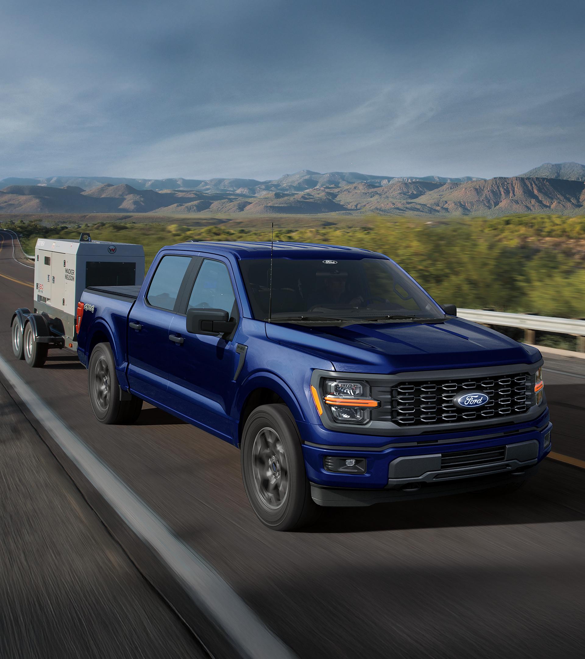 2026 Ford F-150® XL pickup pulling a small trailer