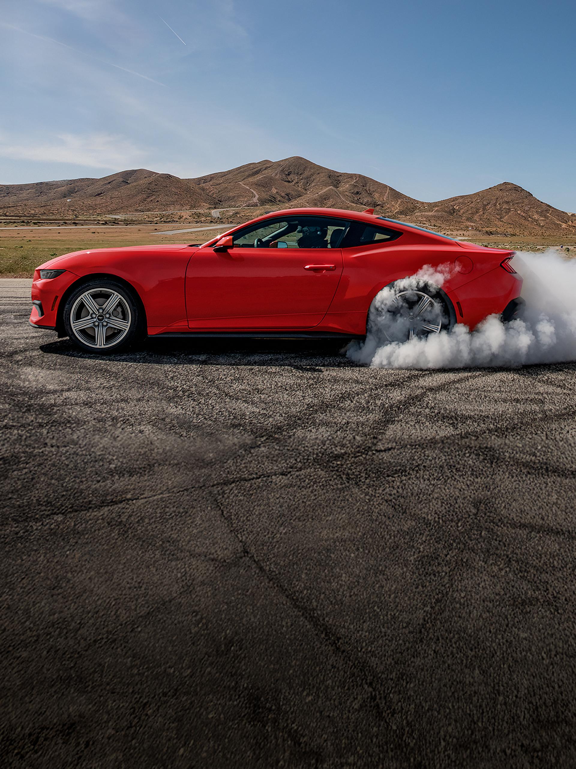 2026 Ford Mustang® EcoBoost® fastback doing a burnout on a racecourse