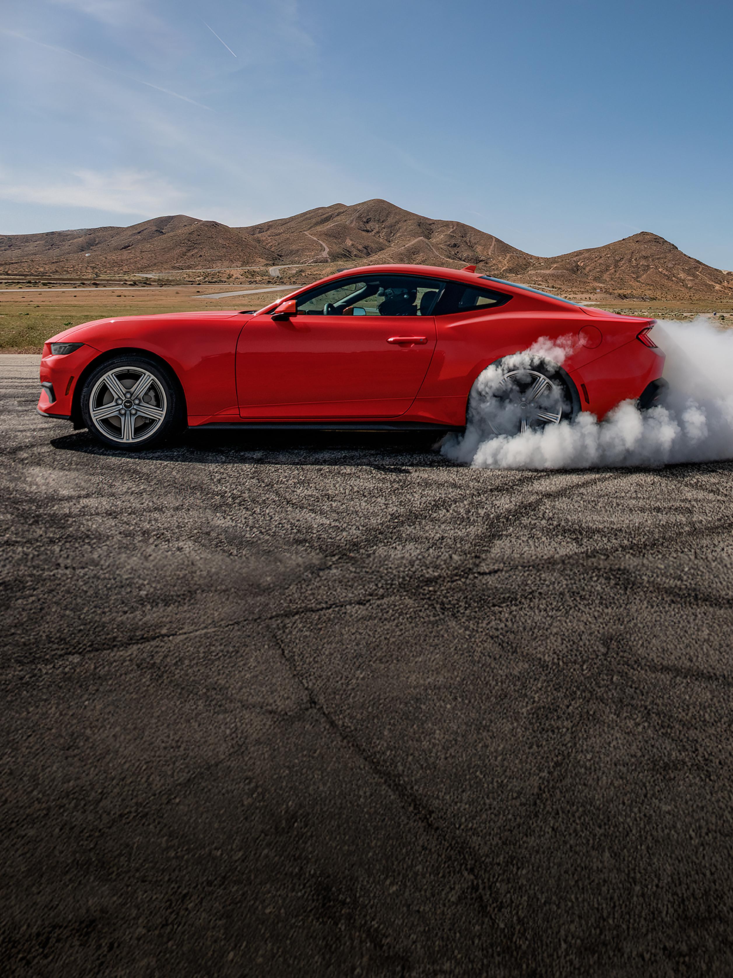 2026 Ford Mustang® EcoBoost® fastback doing a burnout on a racecourse