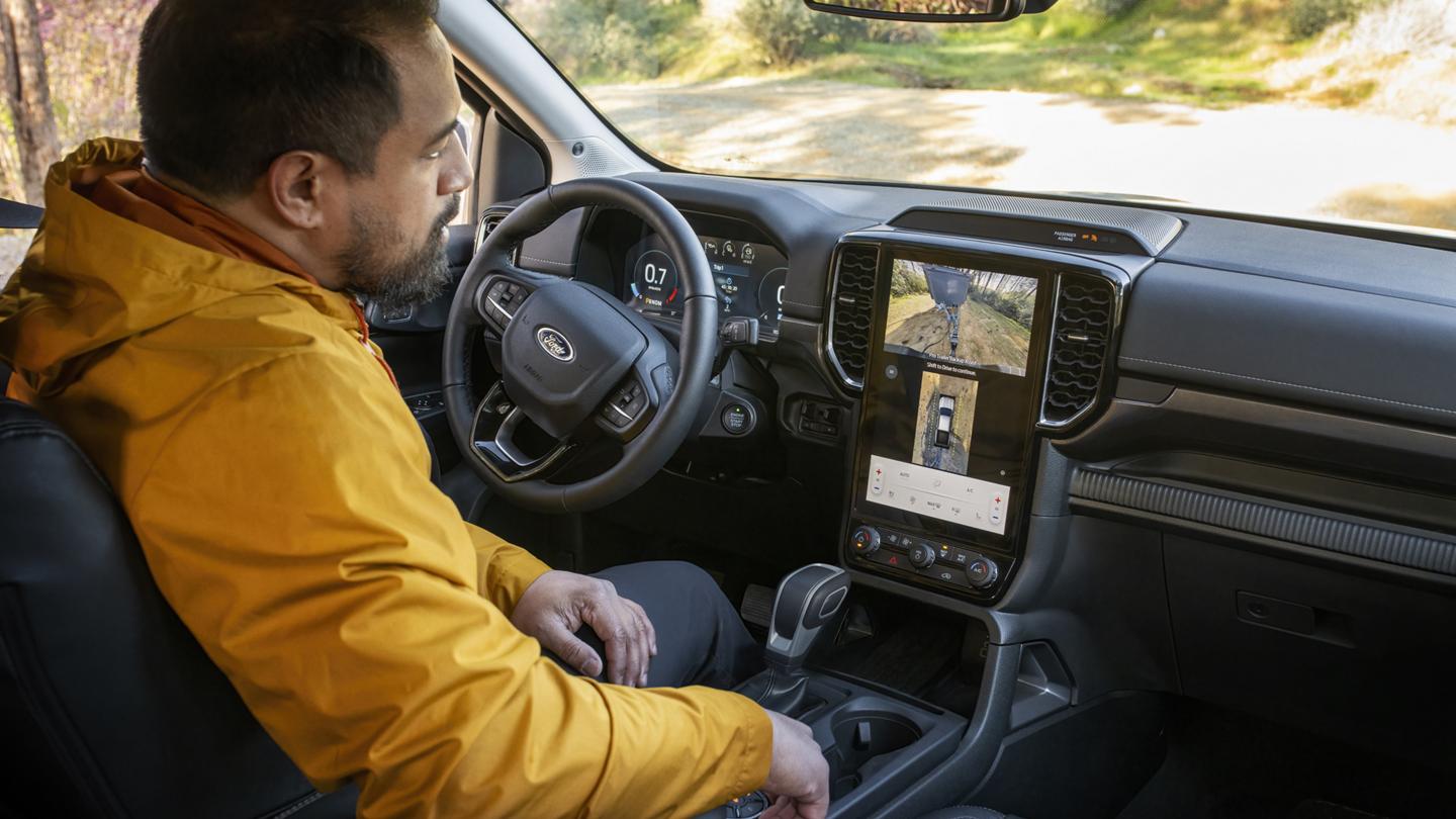 A person using the Pro Trailer Backup Assist feature inside their 2026 Ford Ranger® Lariat® truck