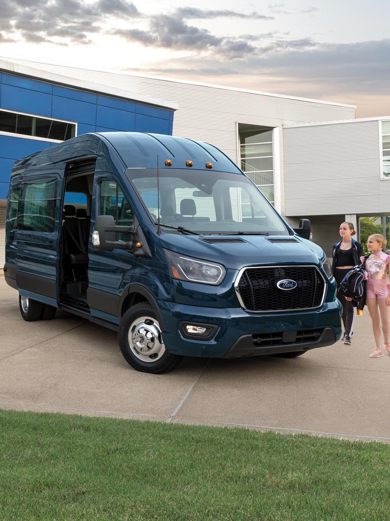 A family near a 2026 Ford Transit® van using the passenger-side door Close Assist feature