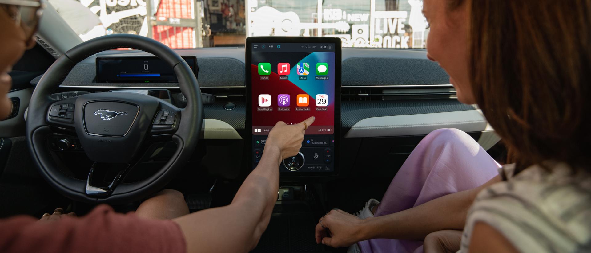 Person using the 15.5" touchscreen with SYNC® 4A in the 2025 Ford Mustang Mach-E®