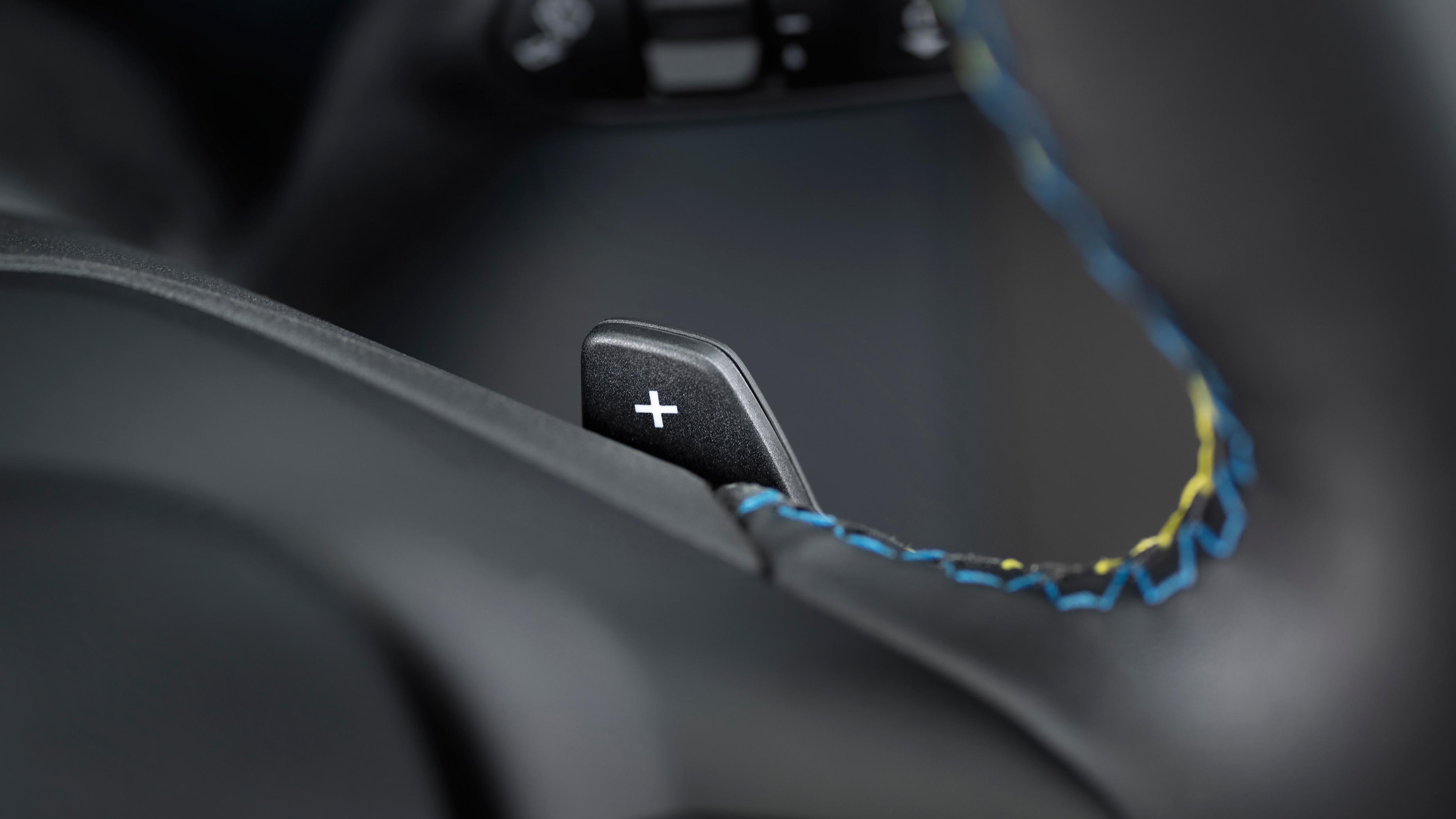 Close-up of the paddle shifter and accent stitching on the steering wheel of a 2026 Ford Maverick® Lobo™ pickup