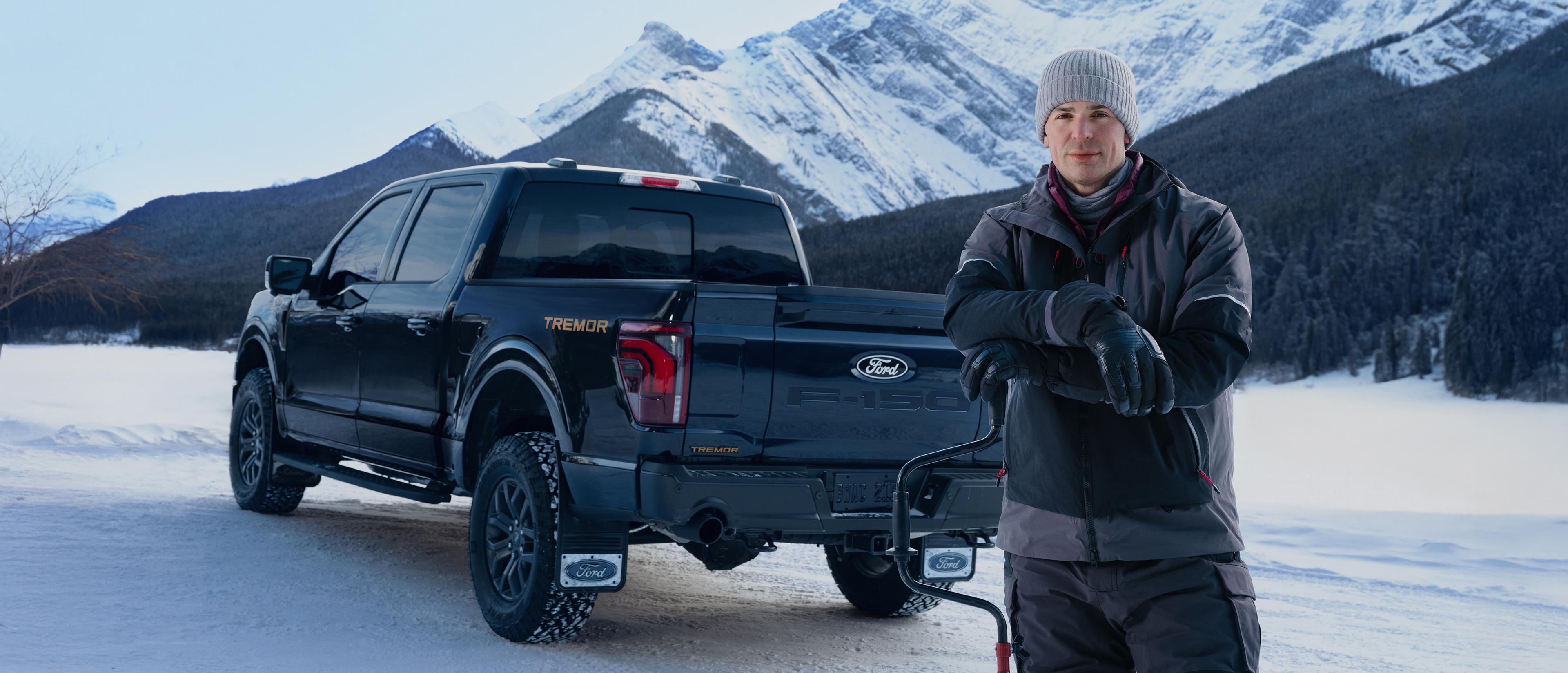 Carey Price stands in front of an F-150 Tremor on a snowy mountain road.