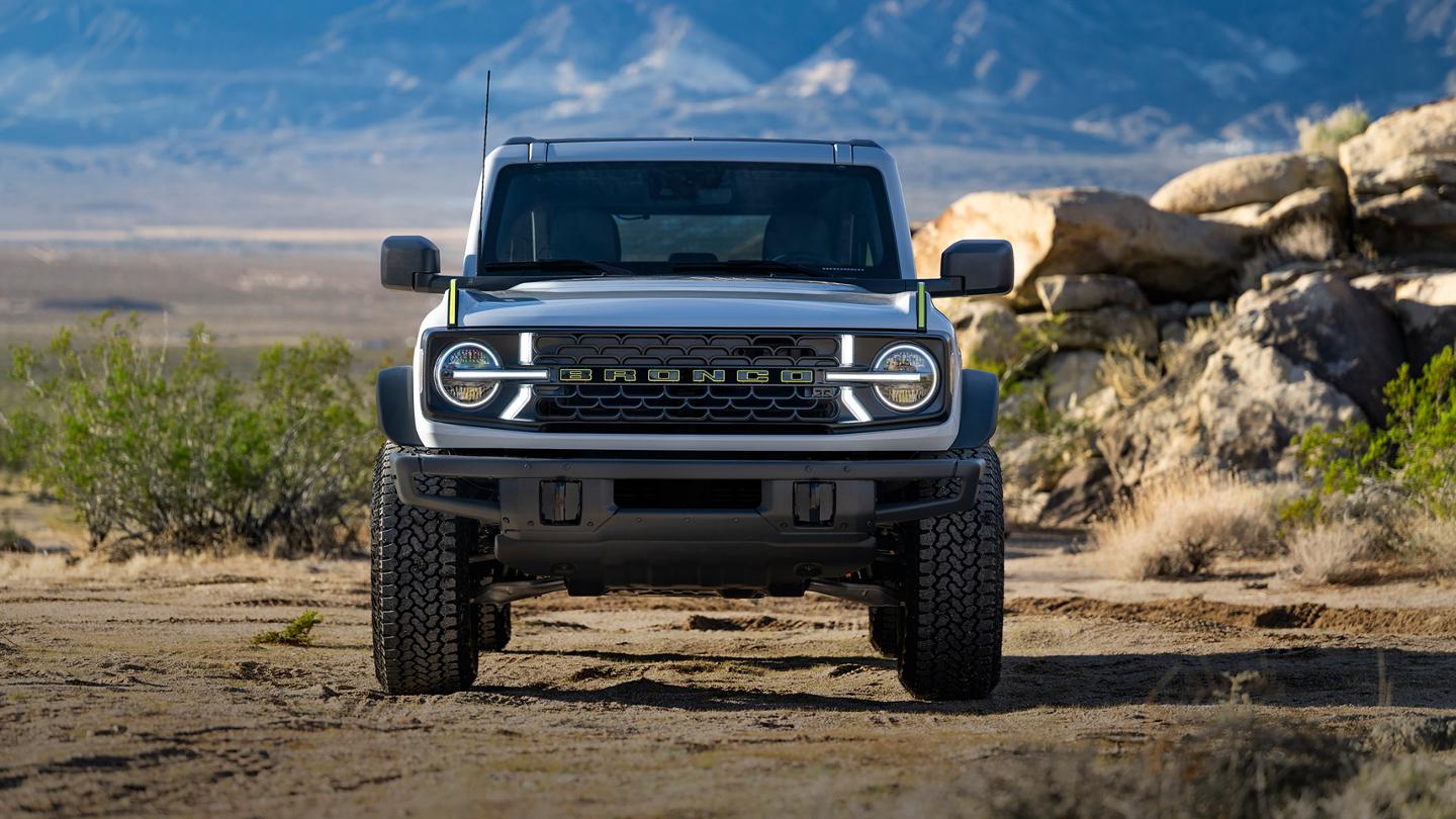 Front view of a 2027 Ford Bronco® RTR model with signature LED lighting illuminated